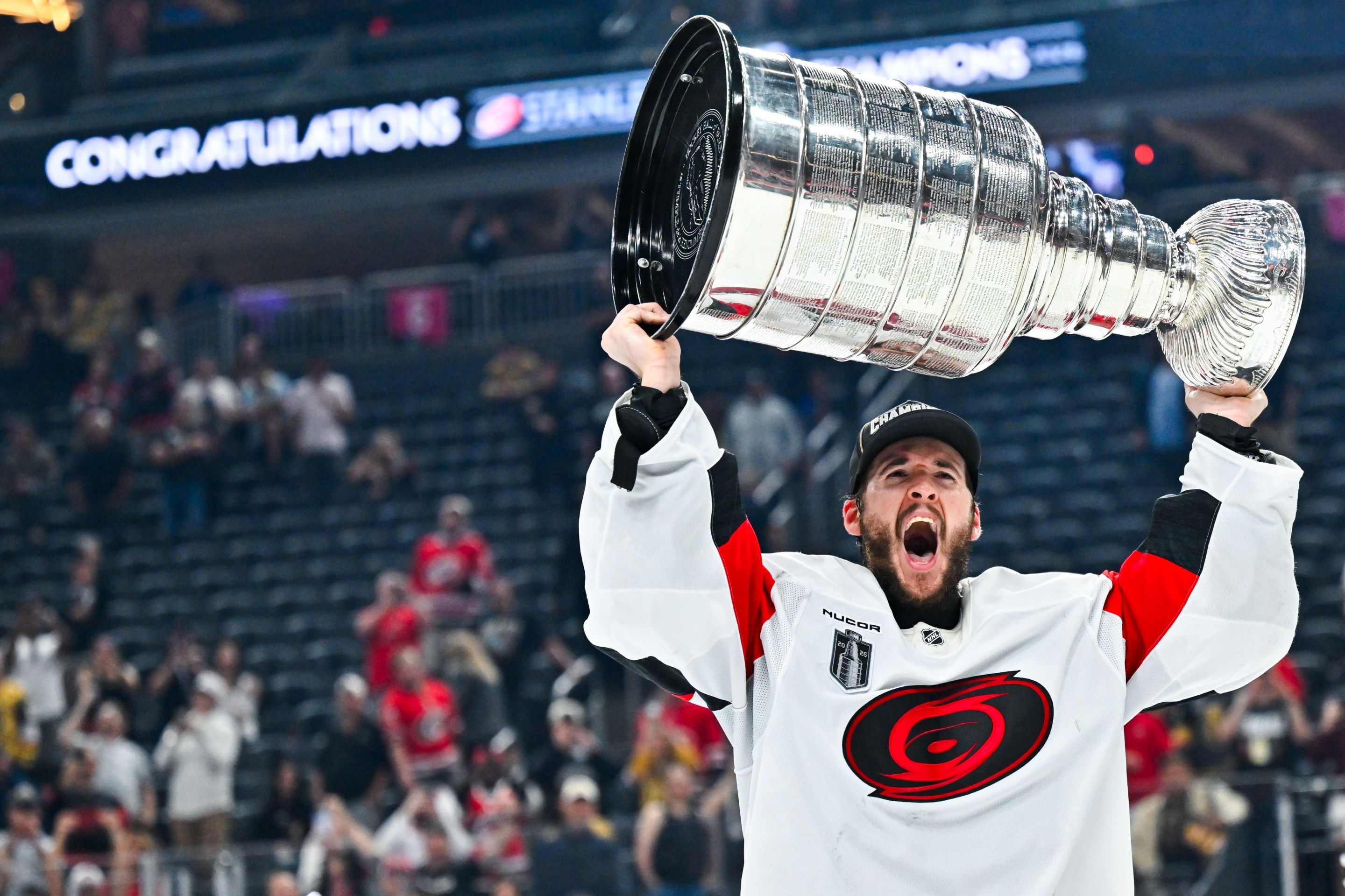 LAS VEGAS, NEVADA - JUNE 14: Brandon Bussi #32 of the Carolina Hurricanes lifts the Stanley Cup after a 3-0 win against the Vegas Golden Knights in Game Six of the 2026 Stanley Cup Final at T-Mobile Arena on June 14, 2026 in Las Vegas, Nevada. (Photo by David Becker/NHLI via Getty Images)