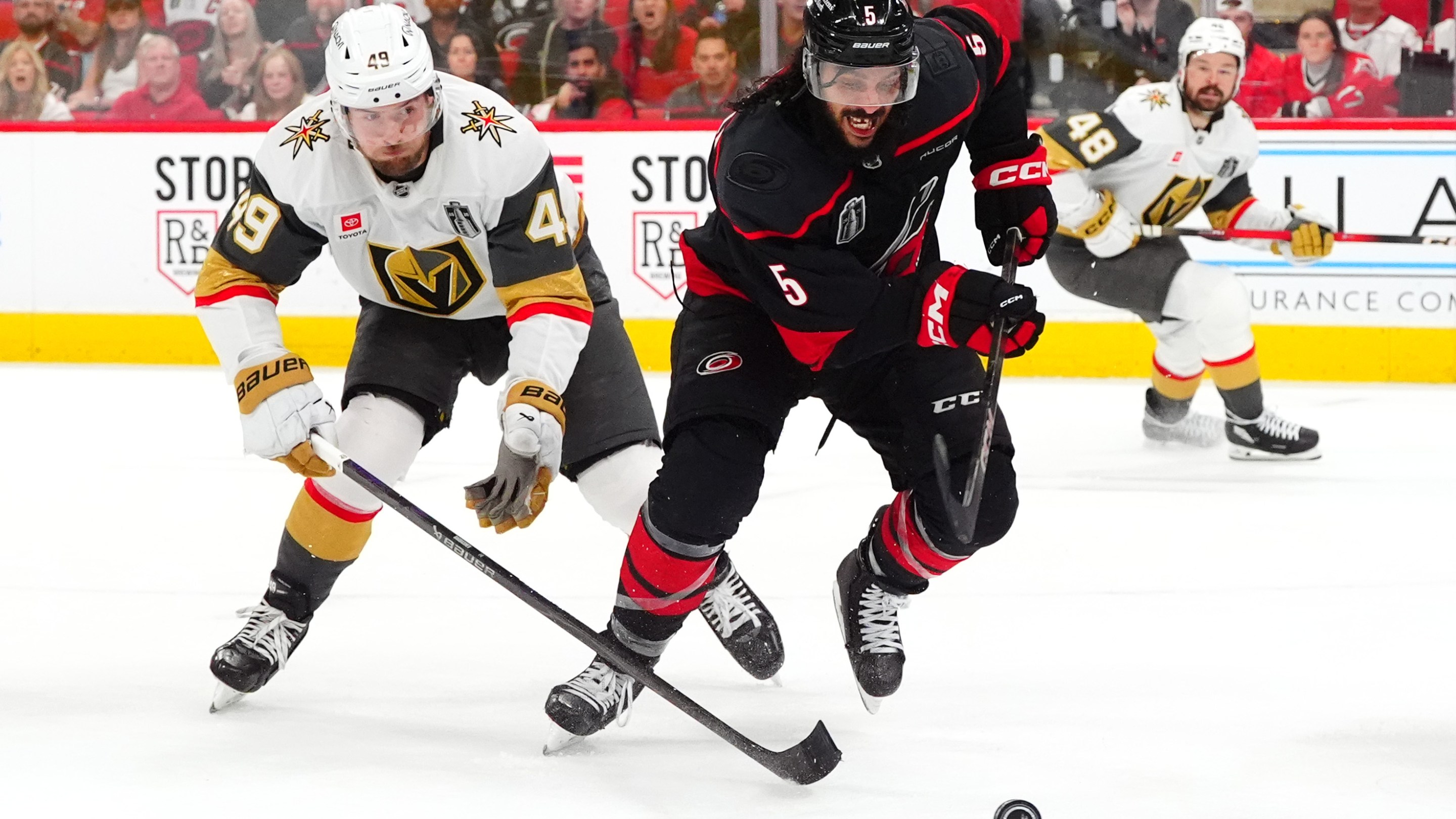RALEIGH, NORTH CAROLINA - JUNE 11: Jalen Chatfield #5 of the Carolina Hurricanes skates away from Ivan Barbashev #49 of the Vegas Golden Knights during the second period of Game Five of the NHL Stanley Cup Final at Lenovo Center on June 11, 2026 in Raleigh, North Carolina. (Photo by Brian Babineau/NHLI via Getty Images)
