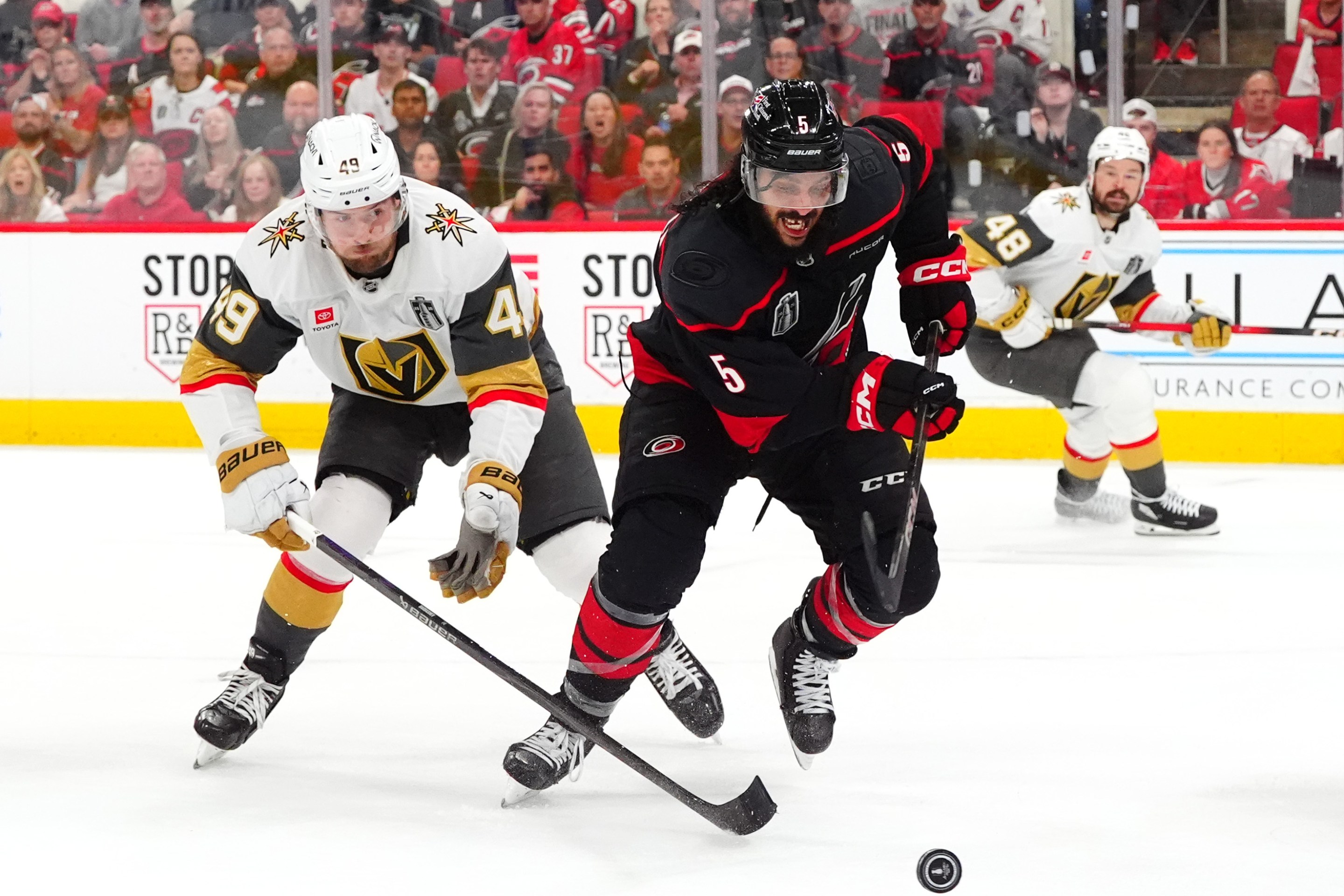 RALEIGH, NORTH CAROLINA - JUNE 11: Jalen Chatfield #5 of the Carolina Hurricanes skates away from Ivan Barbashev #49 of the Vegas Golden Knights during the second period of Game Five of the NHL Stanley Cup Final at Lenovo Center on June 11, 2026 in Raleigh, North Carolina. (Photo by Brian Babineau/NHLI via Getty Images)