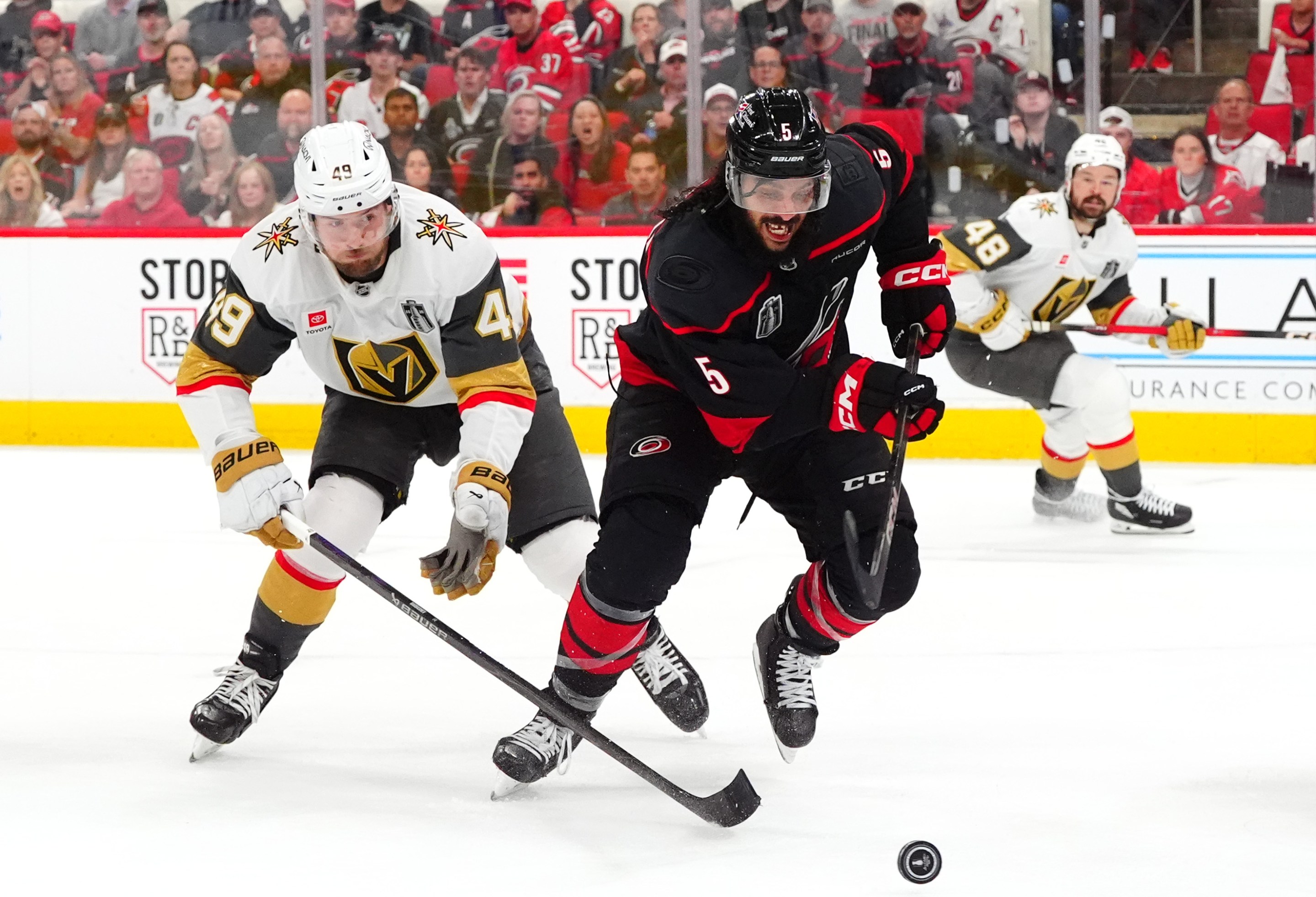 RALEIGH, NORTH CAROLINA - JUNE 11: Jalen Chatfield #5 of the Carolina Hurricanes skates away from Ivan Barbashev #49 of the Vegas Golden Knights during the second period of Game Five of the NHL Stanley Cup Final at Lenovo Center on June 11, 2026 in Raleigh, North Carolina. (Photo by Brian Babineau/NHLI via Getty Images)