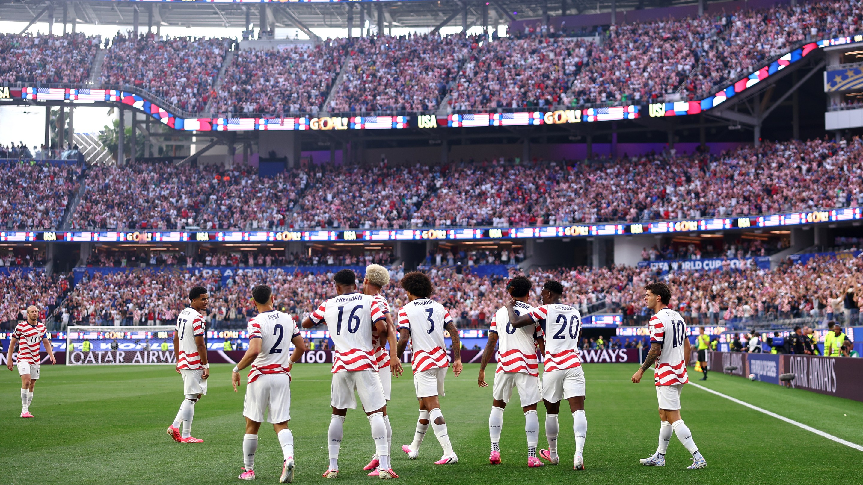 LOS ANGELES, CALIFORNIA - JUNE 12: layers of the United States celebrate their side's first goal, an own goal by Damian Bobadilla #16 of Paraguay (not pictured), during the FIFA World Cup 2026 Group D match between USA and Paraguay at Los Angeles Stadium on June 12, 2026 in Los Angeles, California. (Photo by Dean Mouhtaropoulos/Getty Images)