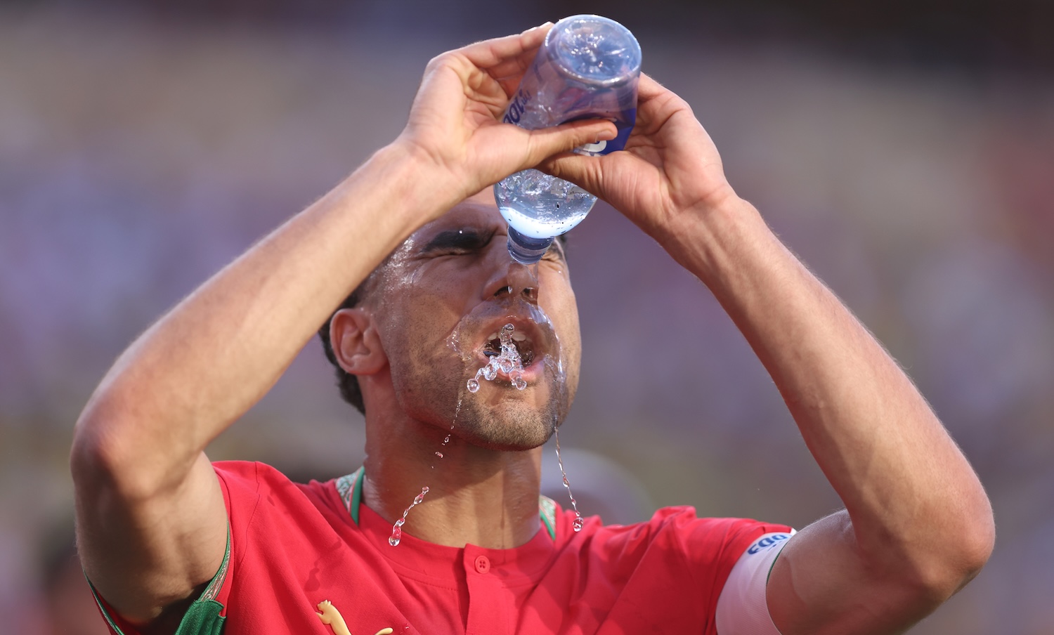 EAST RUTHERFORD, NEW JERSEY - JUNE 13: Achraf Hakimi of Morocco pours water over his face during the FIFA World Cup 2026 Group C match between Brazil and Morocco at New York New Jersey Stadium on June 13, 2026 in East Rutherford, New Jersey. (Photo by Catherine Ivill - AMA/Getty Images)