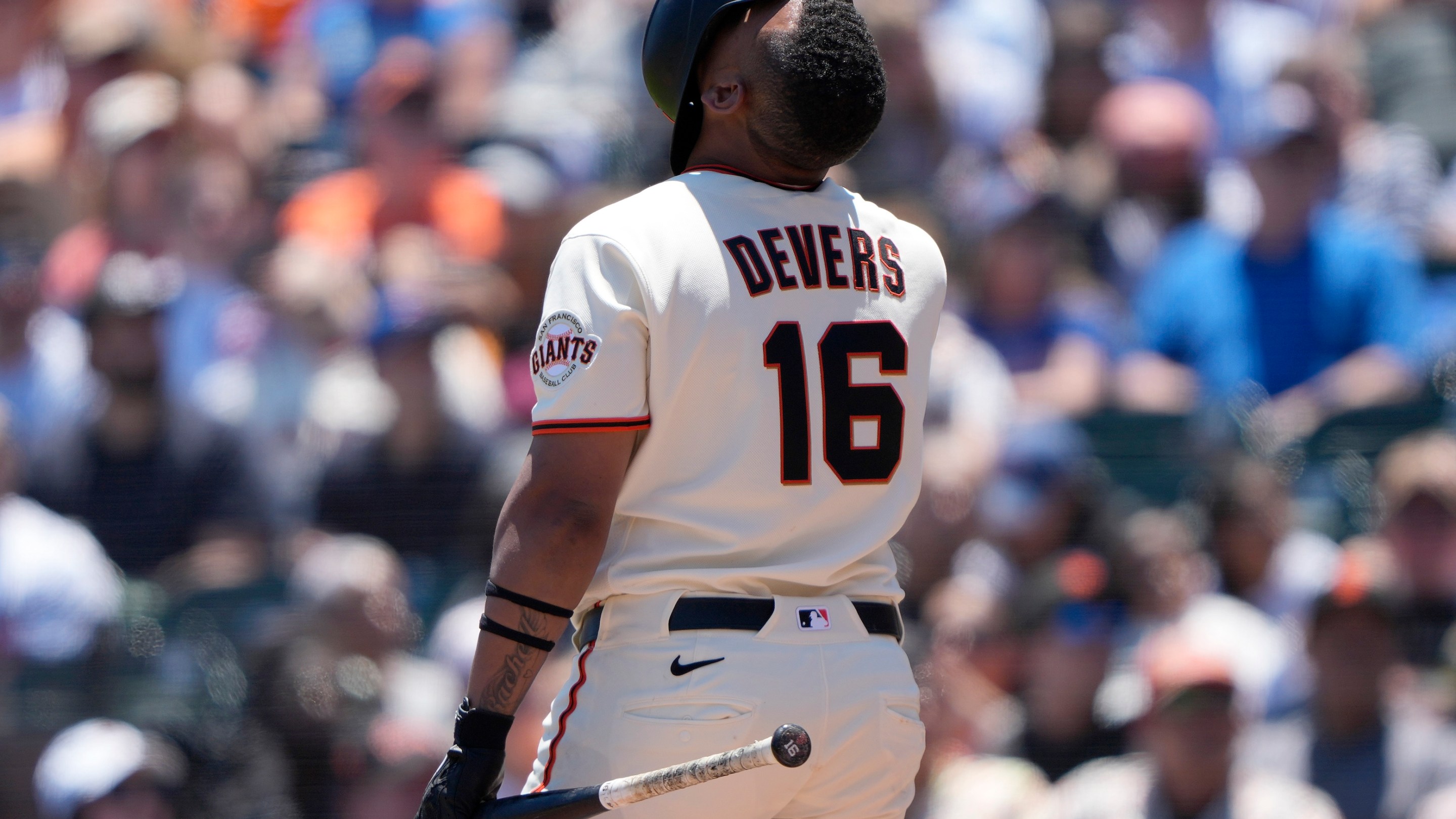 Rafael Devers looking up with his helmet fully over his face after fouling off a pitch against the Chicago Cubs in the bottom of the fifth inning of a major league baseball game at Oracle Park on June 14, 2026 in San Francisco, California.