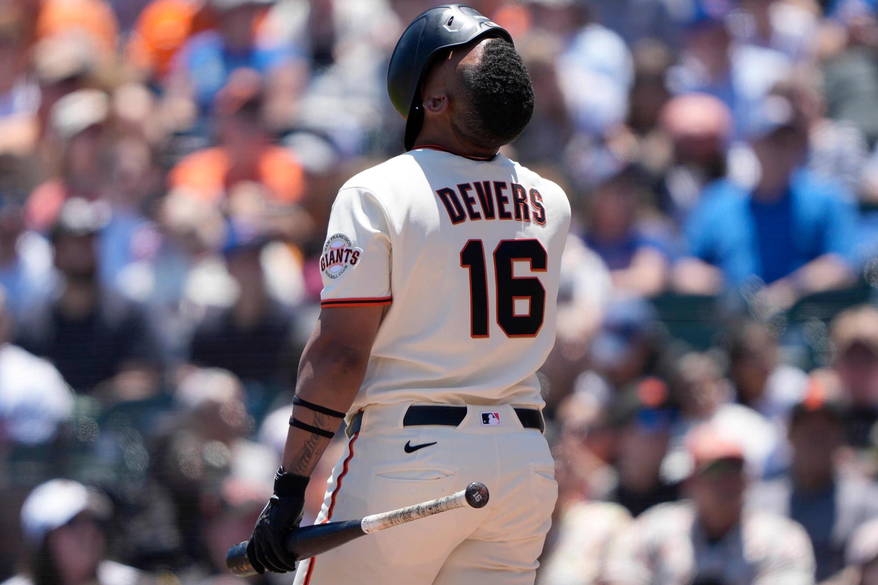 Rafael Devers looking up with his helmet fully over his face after fouling off a pitch against the Chicago Cubs in the bottom of the fifth inning of a major league baseball game at Oracle Park on June 14, 2026 in San Francisco, California.