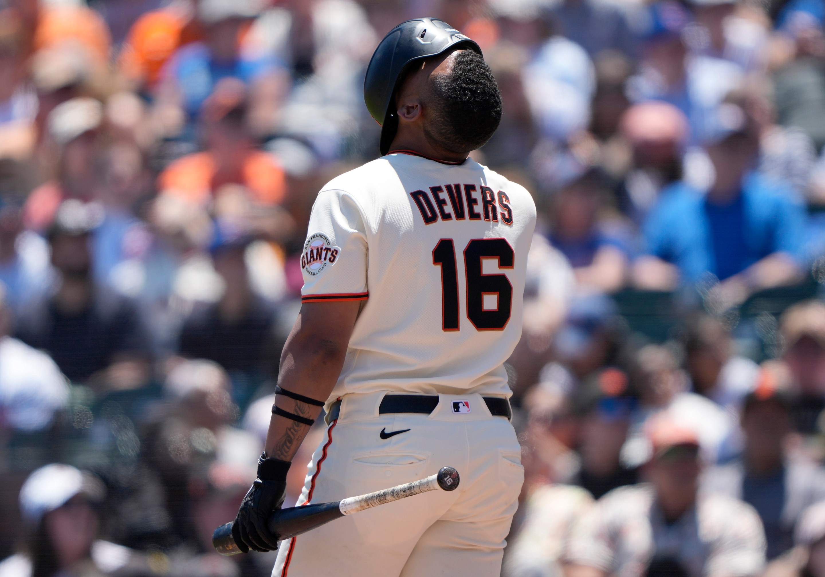 Rafael Devers looking up with his helmet fully over his face after fouling off a pitch against the Chicago Cubs in the bottom of the fifth inning of a major league baseball game at Oracle Park on June 14, 2026 in San Francisco, California.