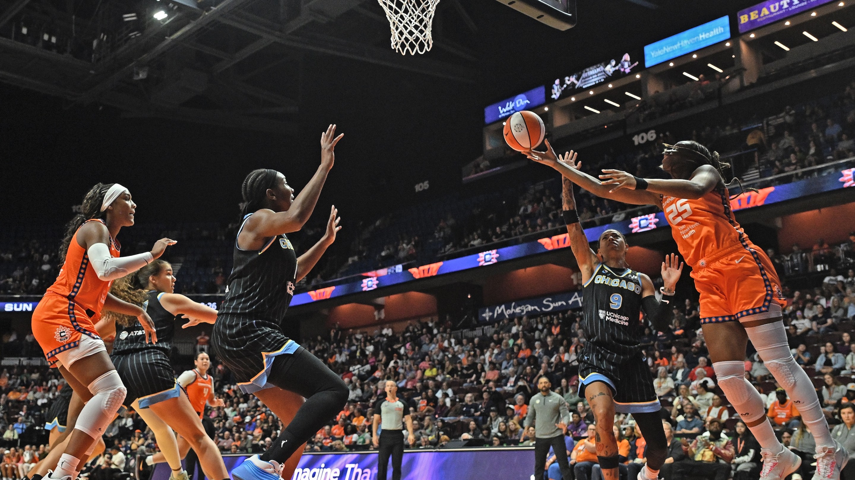 UNCASVILLE, CONNECTICUT - JUNE 22: Kennedy Burke #25 of the Connecticut Sun goes up for a shot defended by Natasha Cloud #9 of the Chicago Sky in the first quarter at Mohegan Sun Arena on June 22, 2026 in Uncasville, Connecticut.