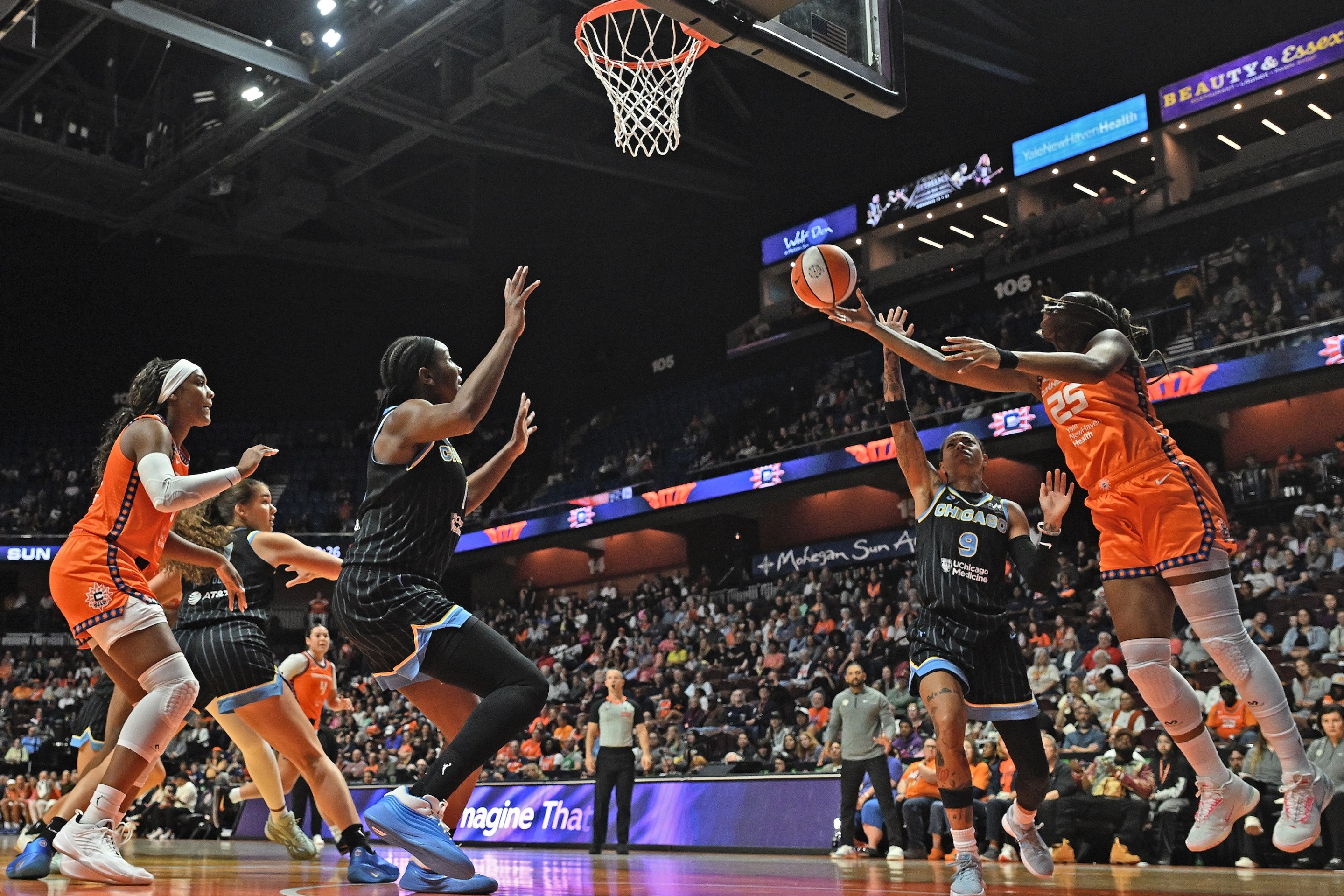 UNCASVILLE, CONNECTICUT - JUNE 22: Kennedy Burke #25 of the Connecticut Sun goes up for a shot defended by Natasha Cloud #9 of the Chicago Sky in the first quarter at Mohegan Sun Arena on June 22, 2026 in Uncasville, Connecticut.