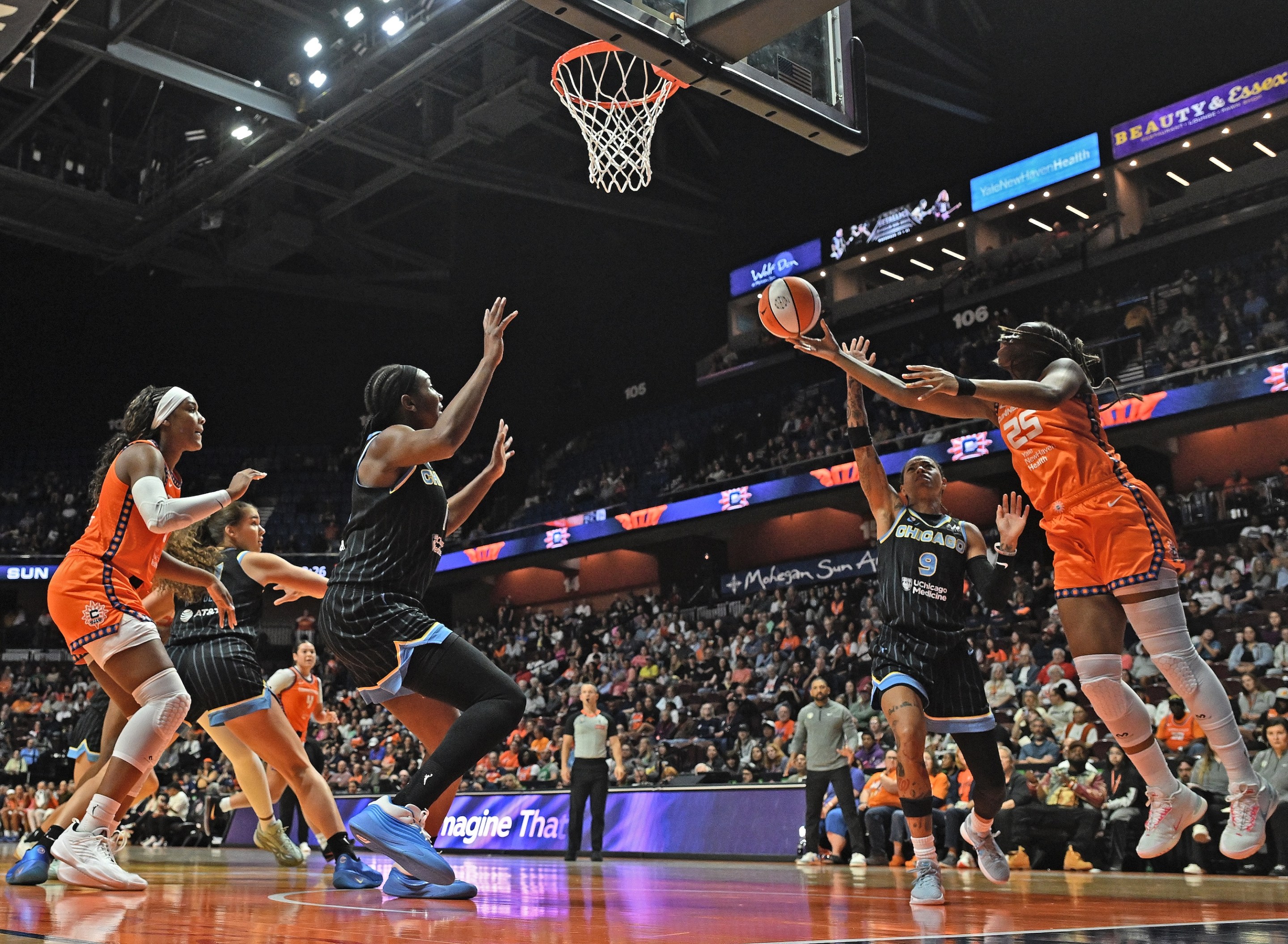 UNCASVILLE, CONNECTICUT - JUNE 22: Kennedy Burke #25 of the Connecticut Sun goes up for a shot defended by Natasha Cloud #9 of the Chicago Sky in the first quarter at Mohegan Sun Arena on June 22, 2026 in Uncasville, Connecticut.