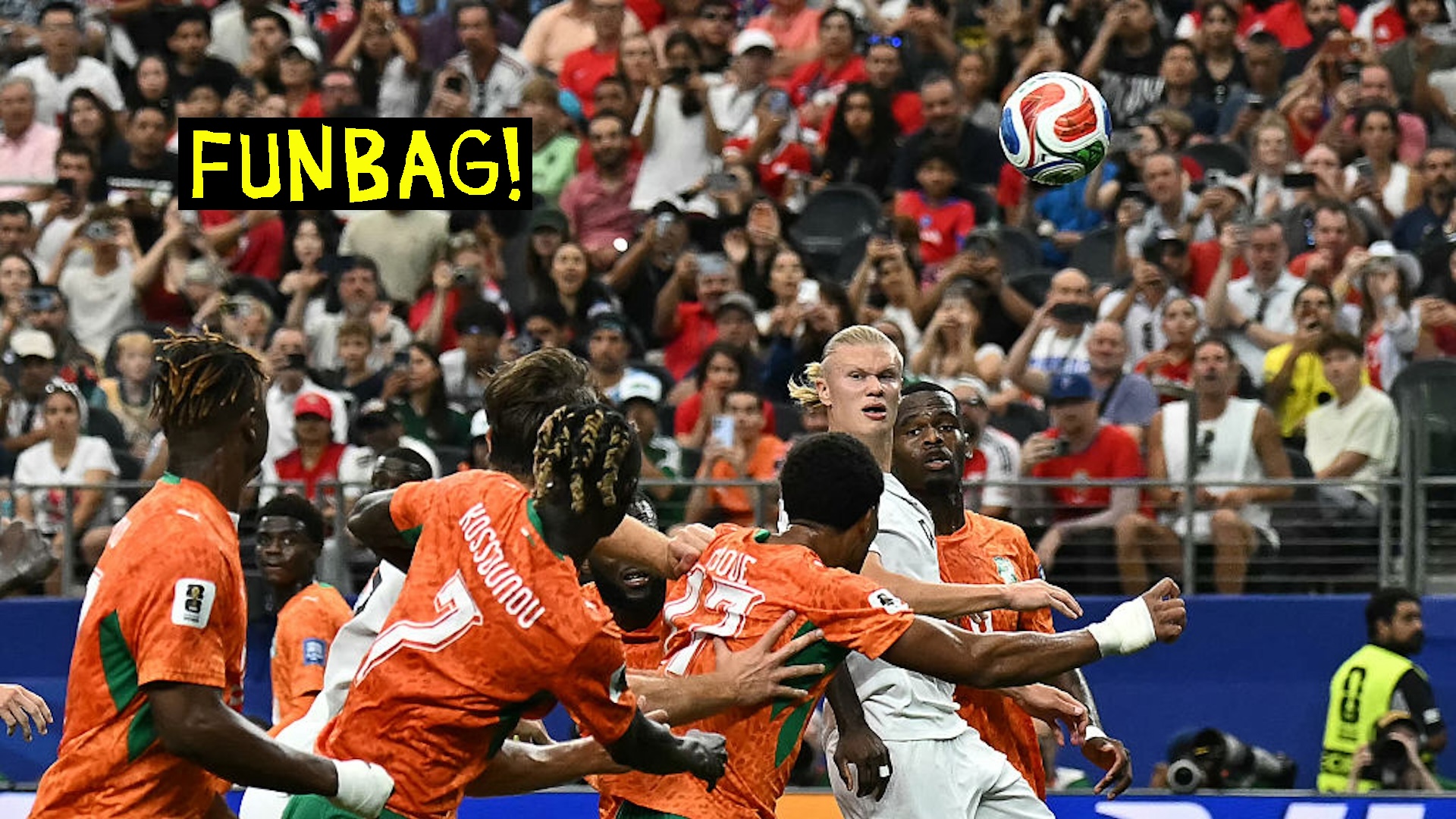 Erling Haaland watches a ball fly over the heads of Ivory Coast players