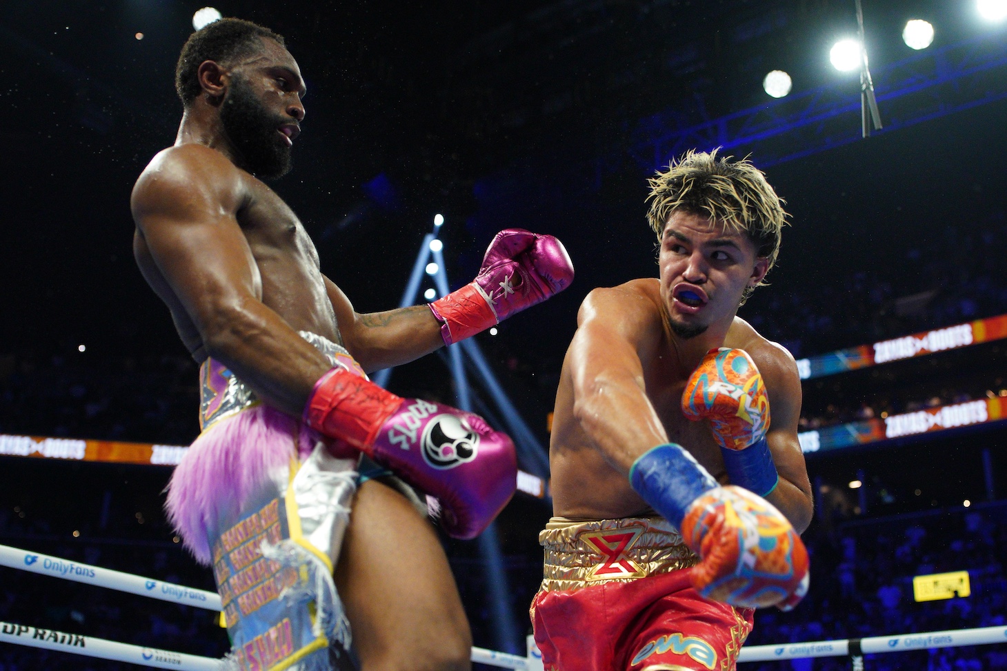 Xander Zayas throws a punch at Jaron 'Boots' Ennis during their WBO and WBA World Super-Welterweight title bout.