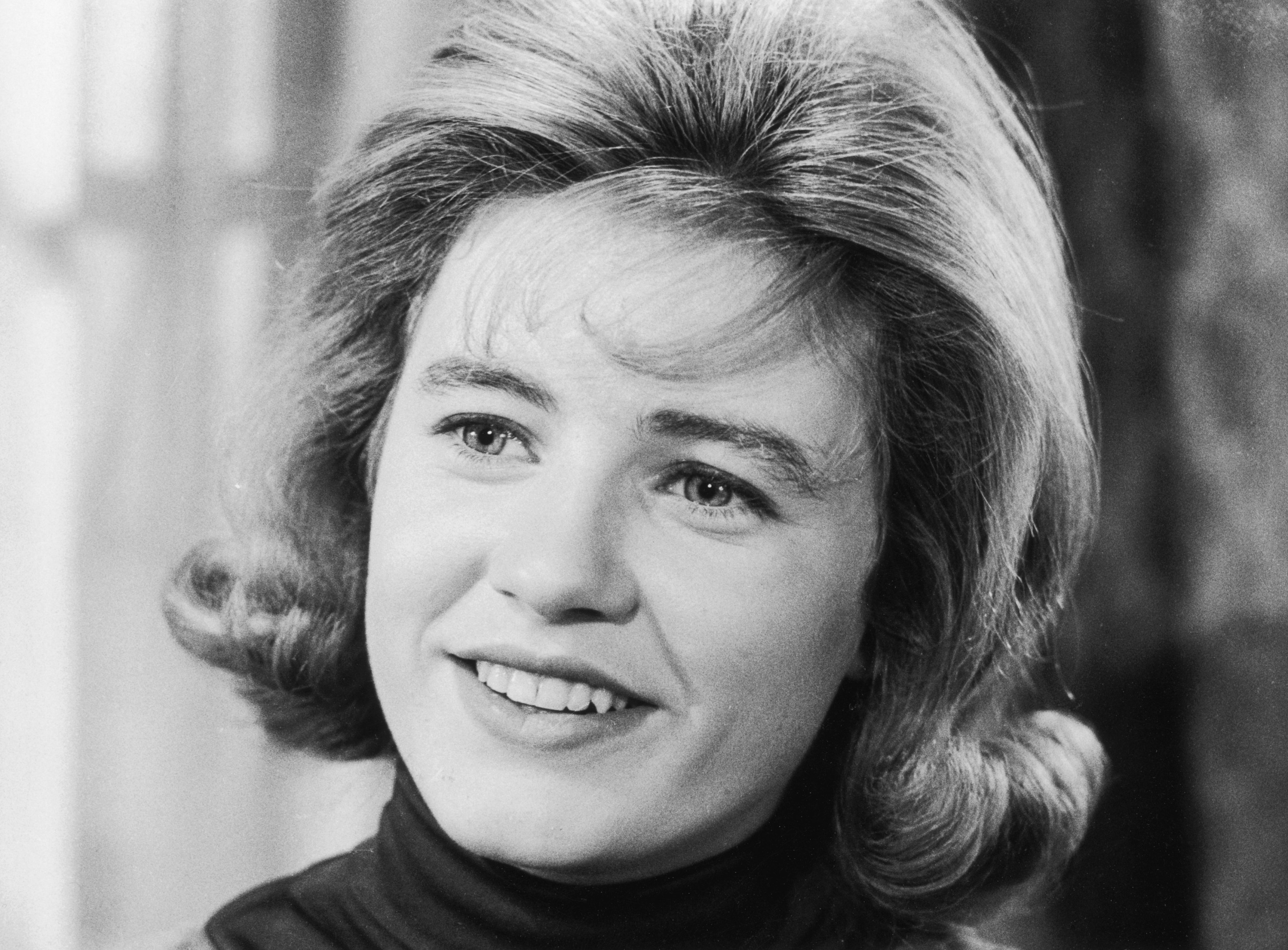 Closeup of American actor Patty Duke smiling in a still from the television series 'The Patty Duke Show'.