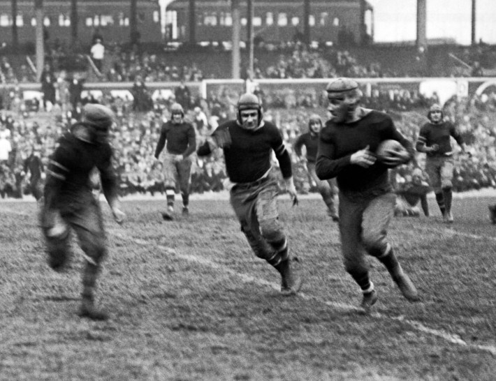 New York Giants rookie running back Heinie Benkert from Rutgers about to be tackled after a 30 yard run in a game against the Rochester Jeffersons, New York, New York, November 11, 1925. He went on to also play for the Pottsville Maroons and the Orange/Newark Tornadoes. (Photo by Underwood Archives/Getty Images)