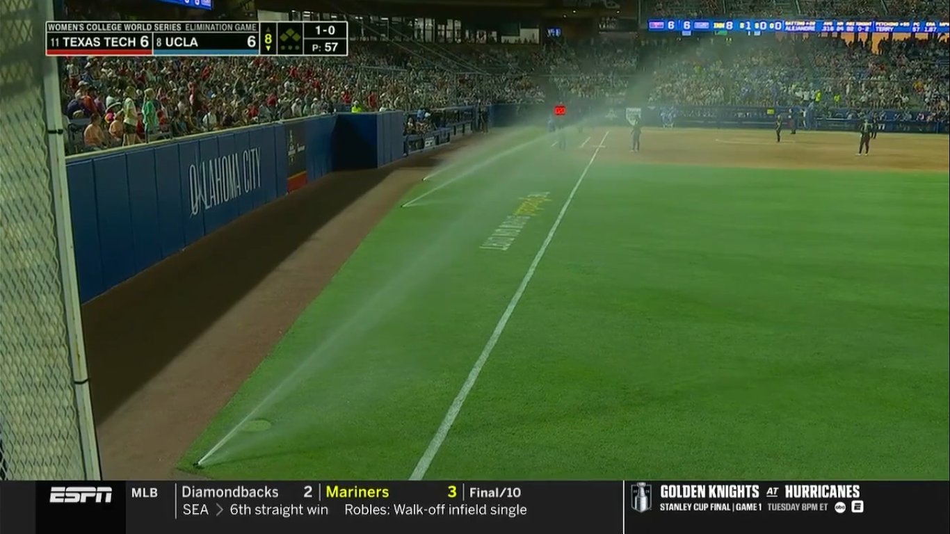 sprinklers spraying the field with players on it