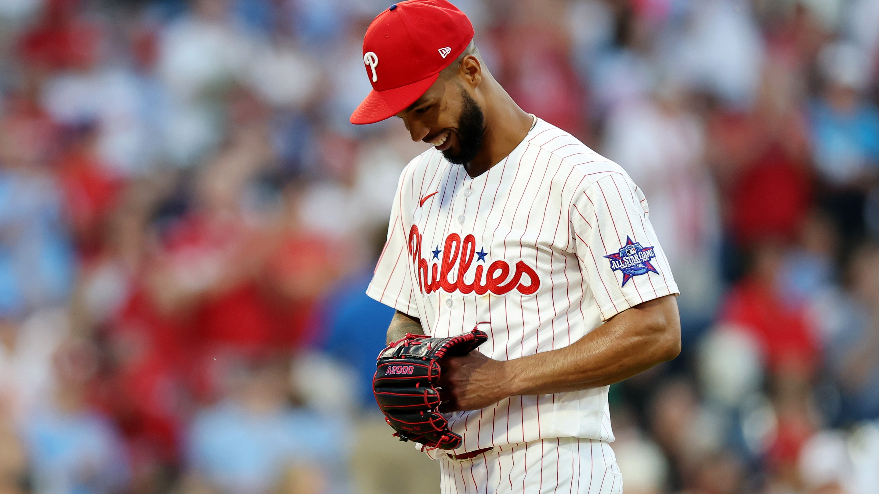 Cristopher Sánchez #61 of the Philadelphia Phillies smiles after a strike out in the sixth inning during a game against the San Diego Padres.