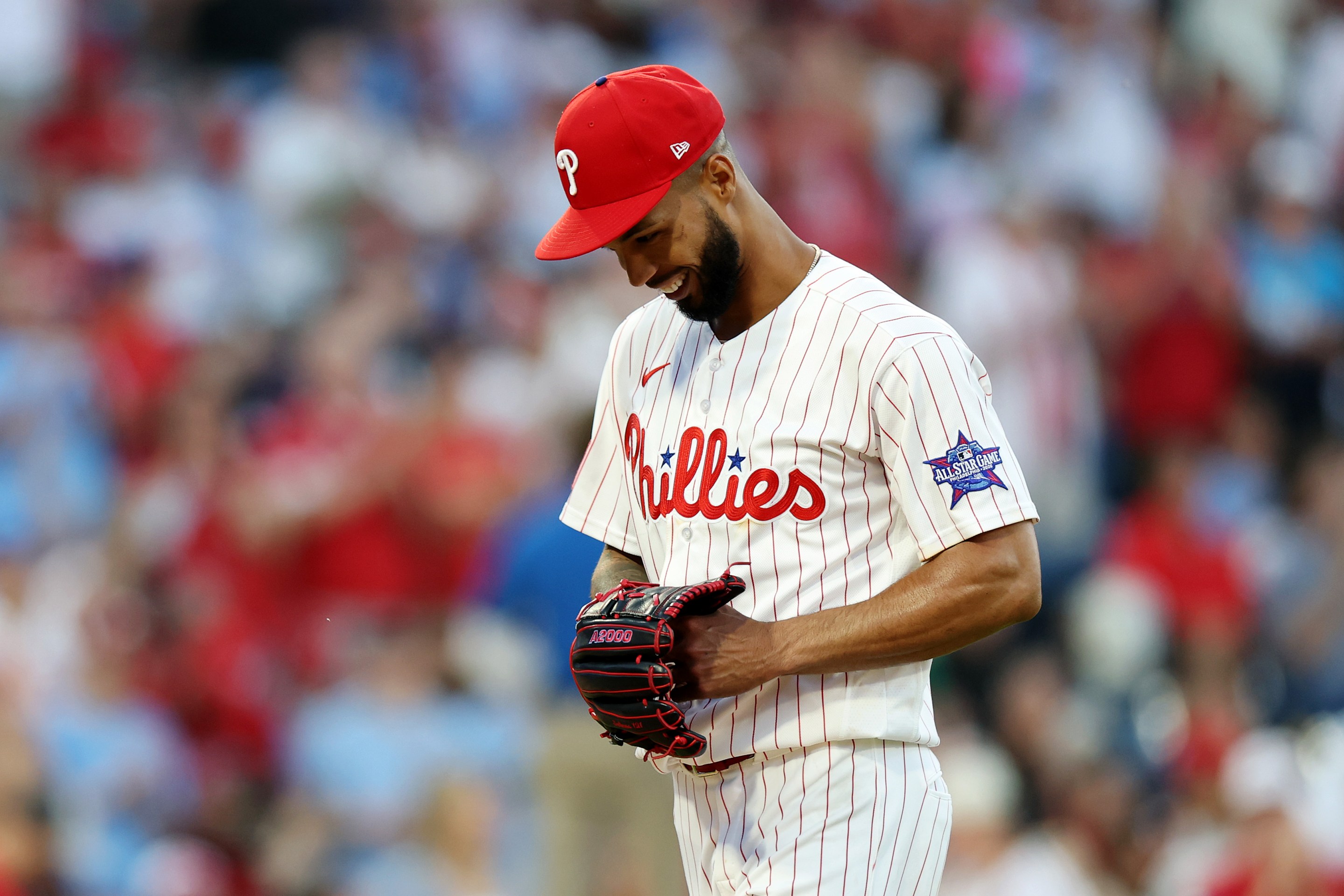 Cristopher Sánchez #61 of the Philadelphia Phillies smiles after a strike out in the sixth inning during a game against the San Diego Padres.