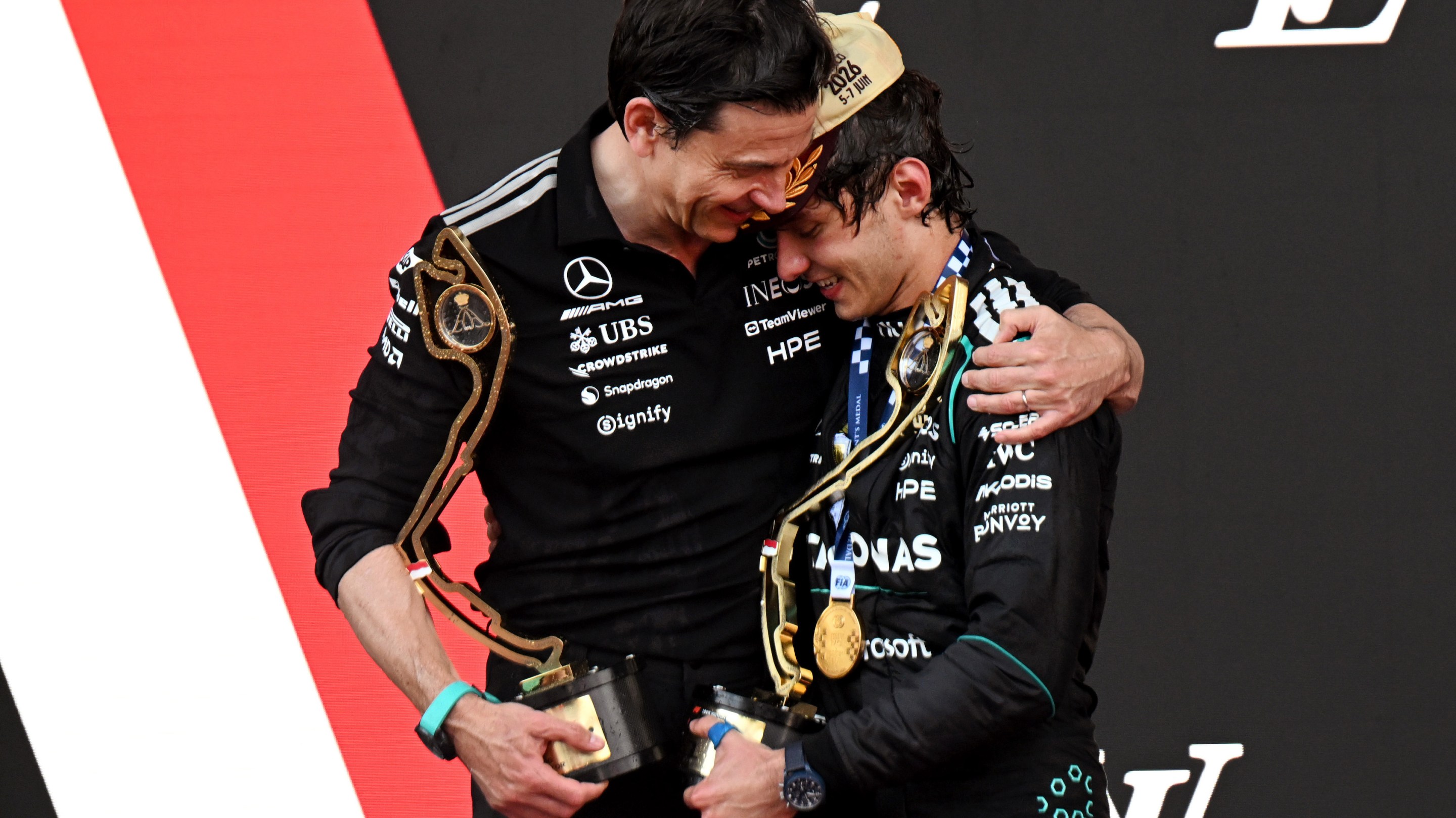 Race winner Andrea Kimi Antonelli of Italy and Mercedes AMG Petronas F1 Team and Toto Wolff, Executive Director of Mercedes AMG Petronas F1 Team celebrate on the podium.