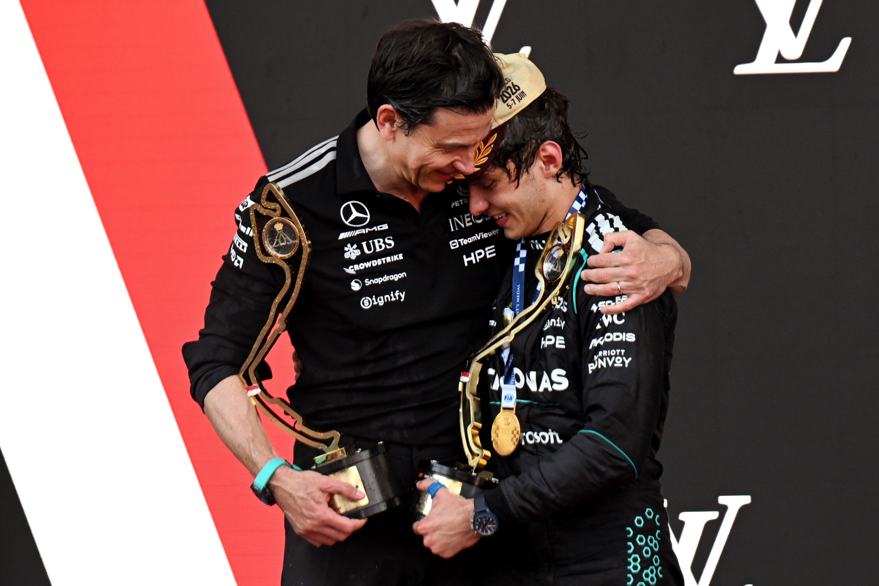 Race winner Andrea Kimi Antonelli of Italy and Mercedes AMG Petronas F1 Team and Toto Wolff, Executive Director of Mercedes AMG Petronas F1 Team celebrate on the podium.