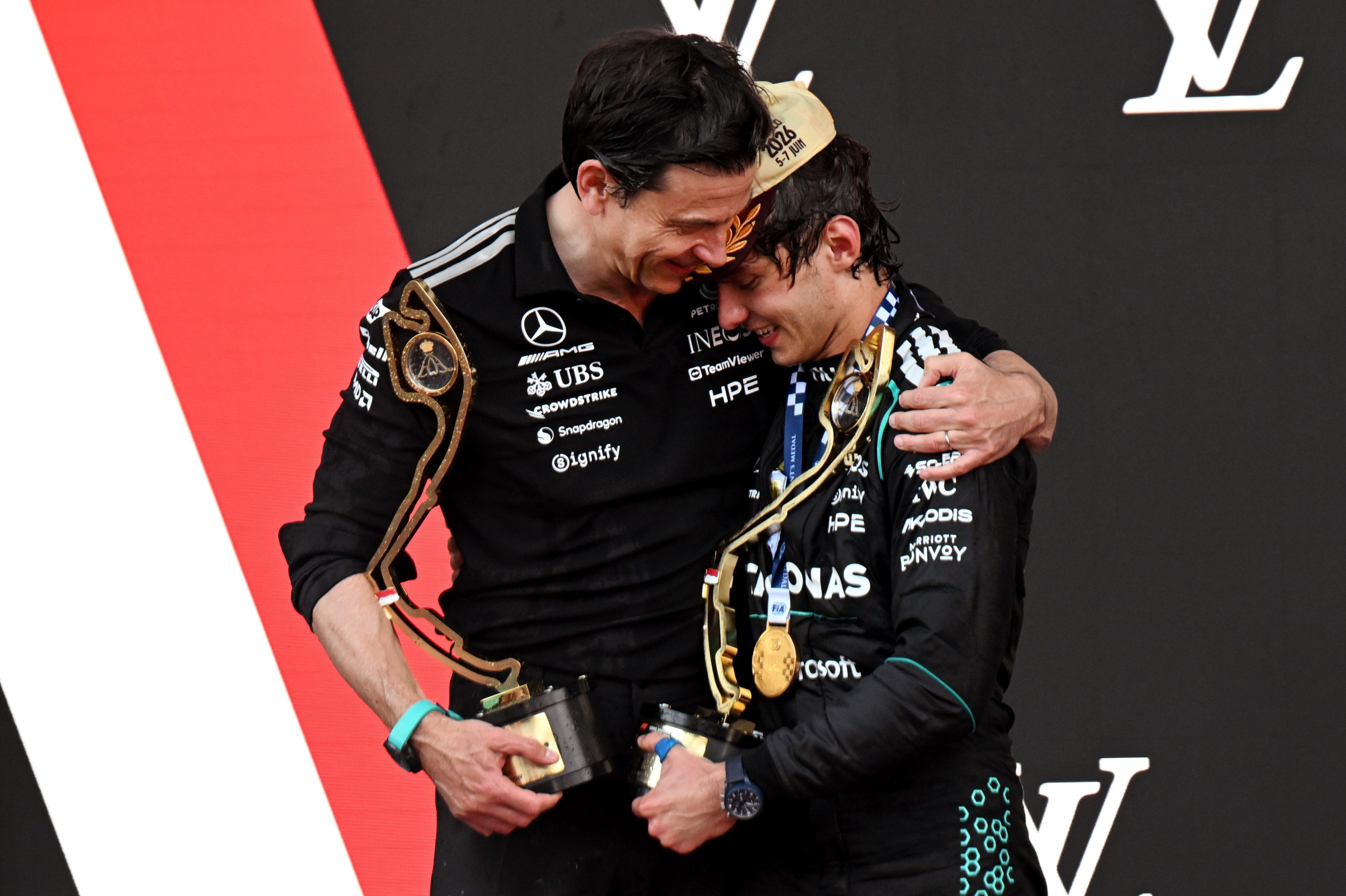 Race winner Andrea Kimi Antonelli of Italy and Mercedes AMG Petronas F1 Team and Toto Wolff, Executive Director of Mercedes AMG Petronas F1 Team celebrate on the podium.