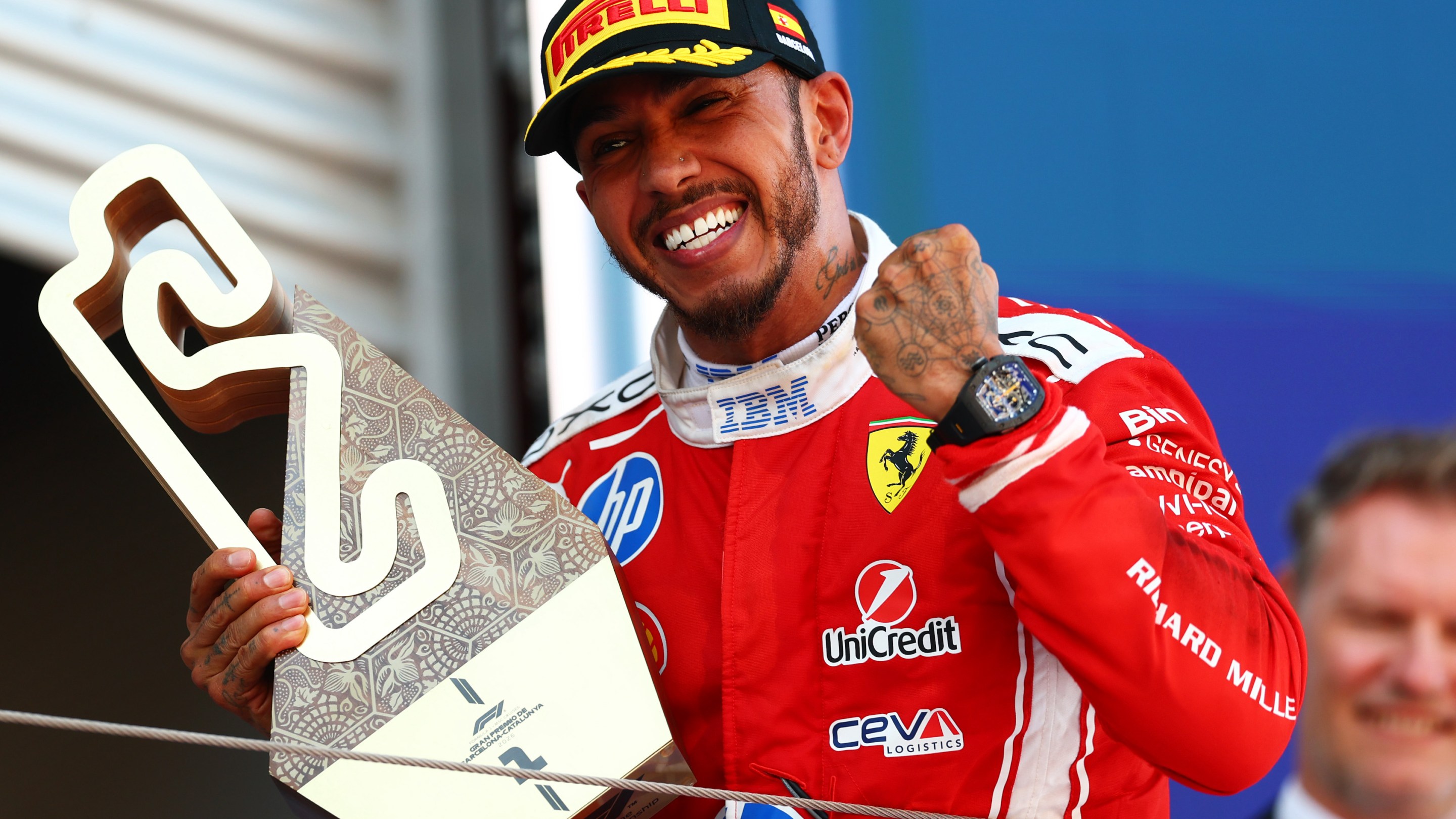 Race winner Lewis Hamilton of Great Britain and Scuderia Ferrari on the podium with his trophy during the F1 Grand Prix of Barcelona-Catalunya.