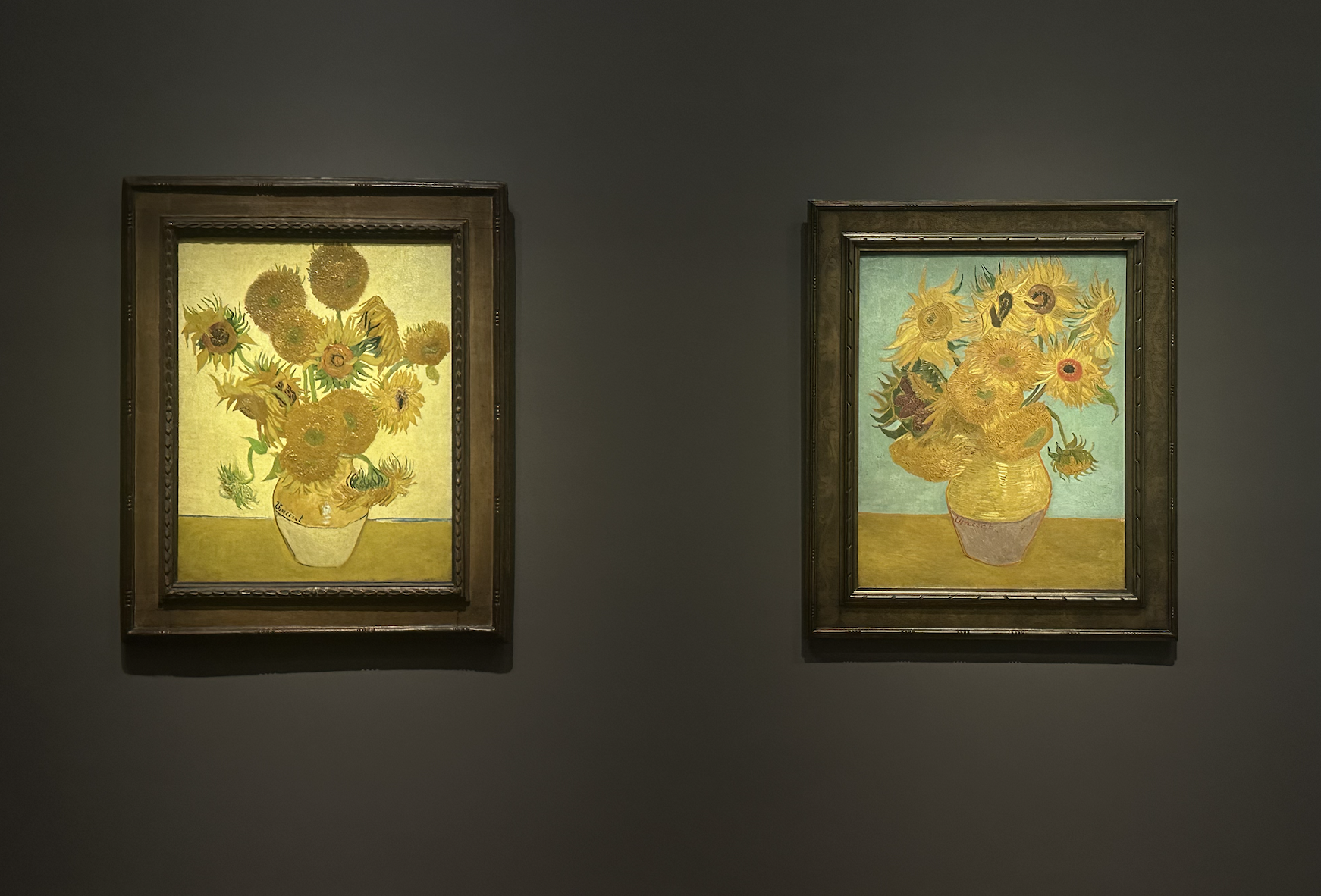 two van gogh paintings on a dark background