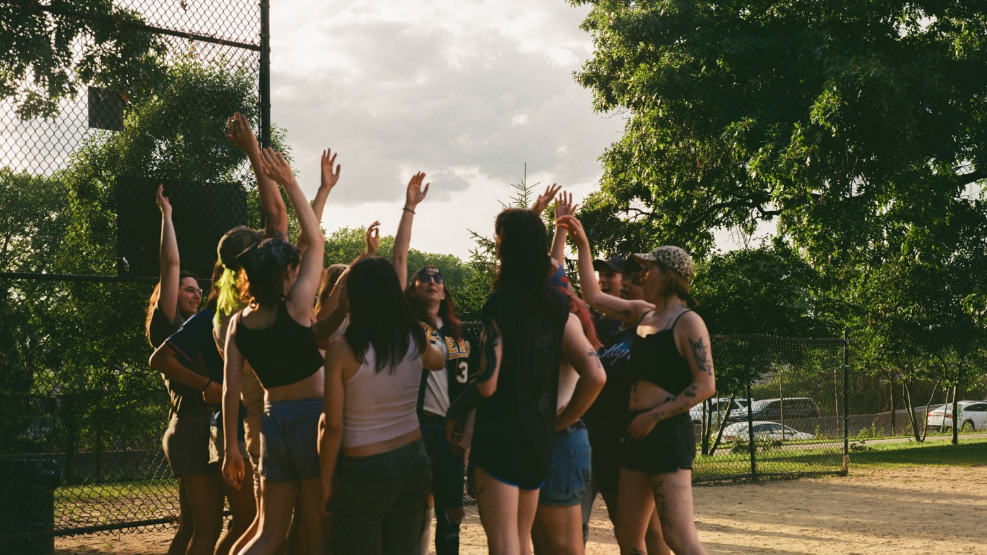 a team circles up and puts their hands in at home plate