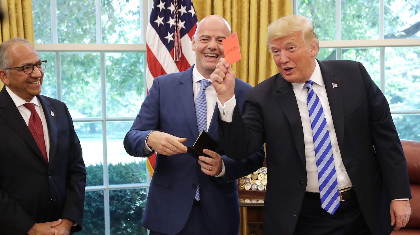 U.S. President Donald Trump poses for photographs with FIFA President Gianni Infantino in the Oval Office at the White House.