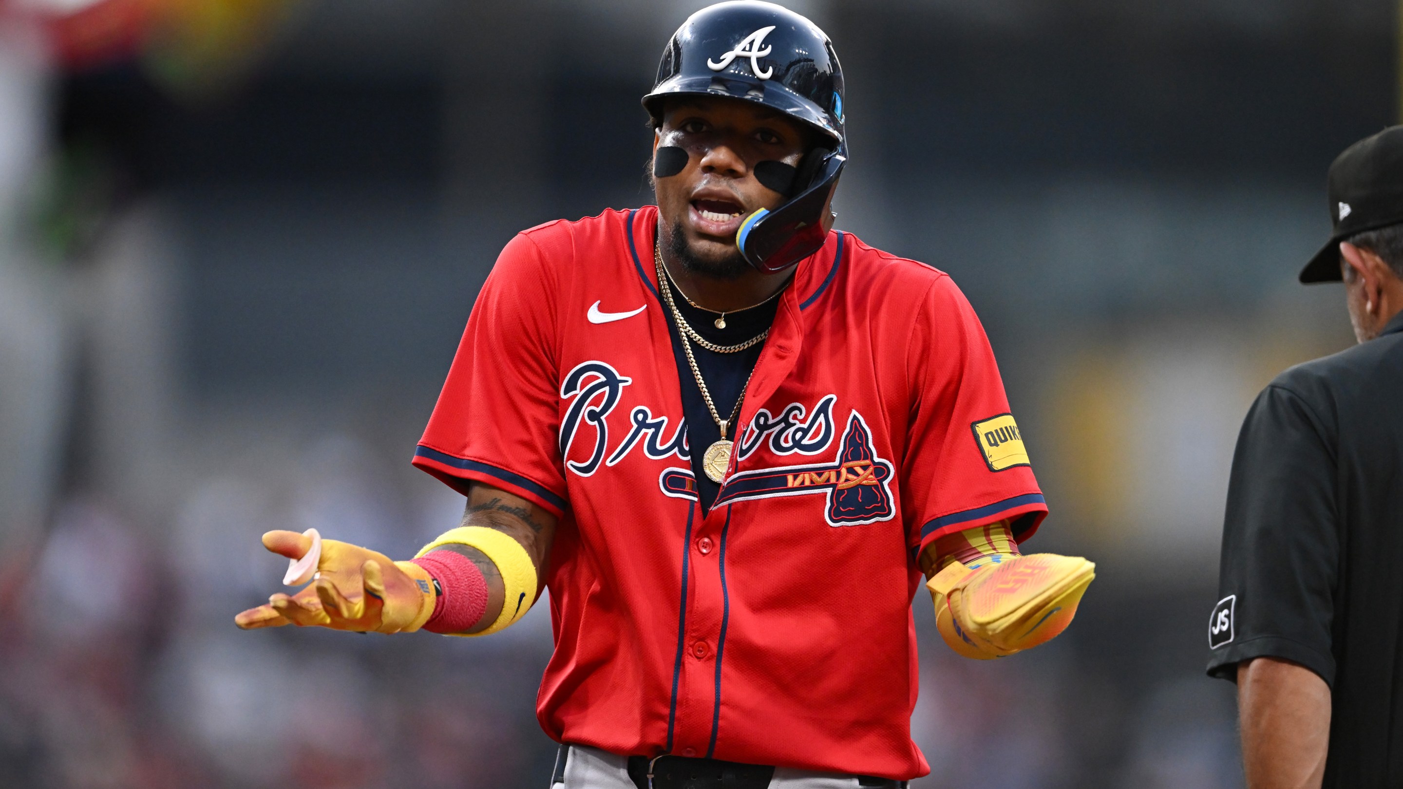 Ronald Acuña Jr. #13 of the Atlanta Braves reacts after being called out for runner's interference