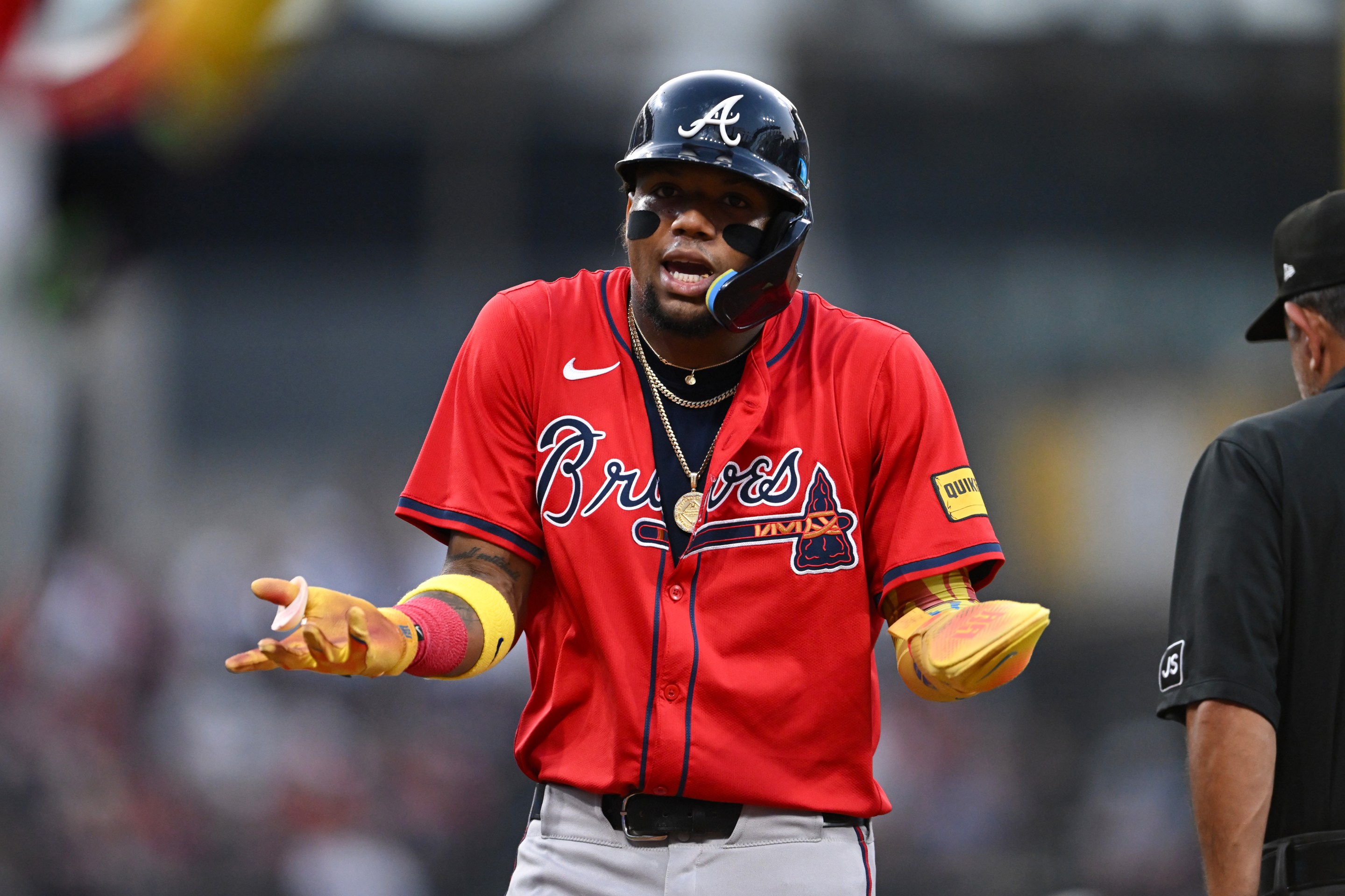 Ronald Acuña Jr. #13 of the Atlanta Braves reacts after being called out for runner's interference