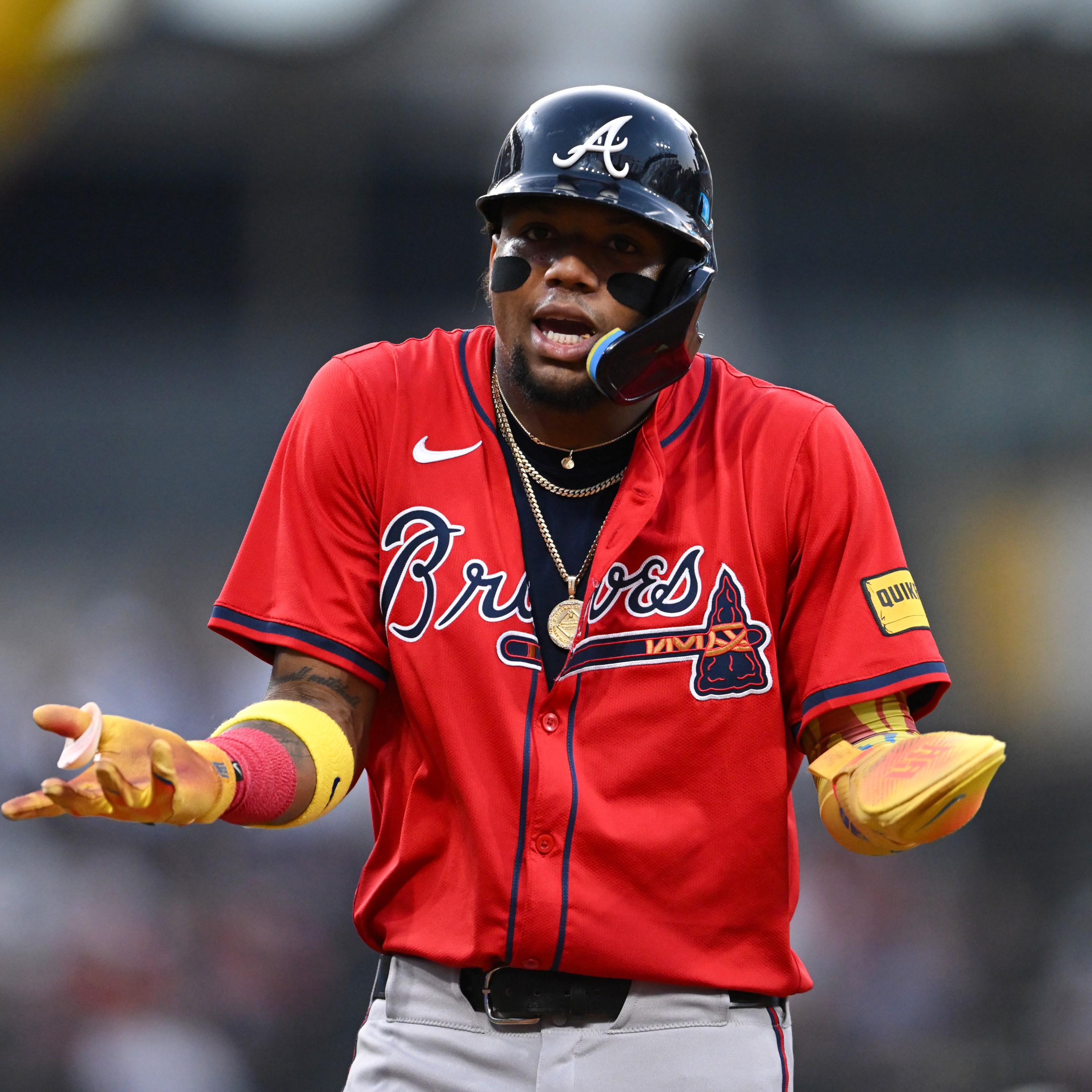 Ronald Acuña Jr. #13 of the Atlanta Braves reacts after being called out for runner's interference