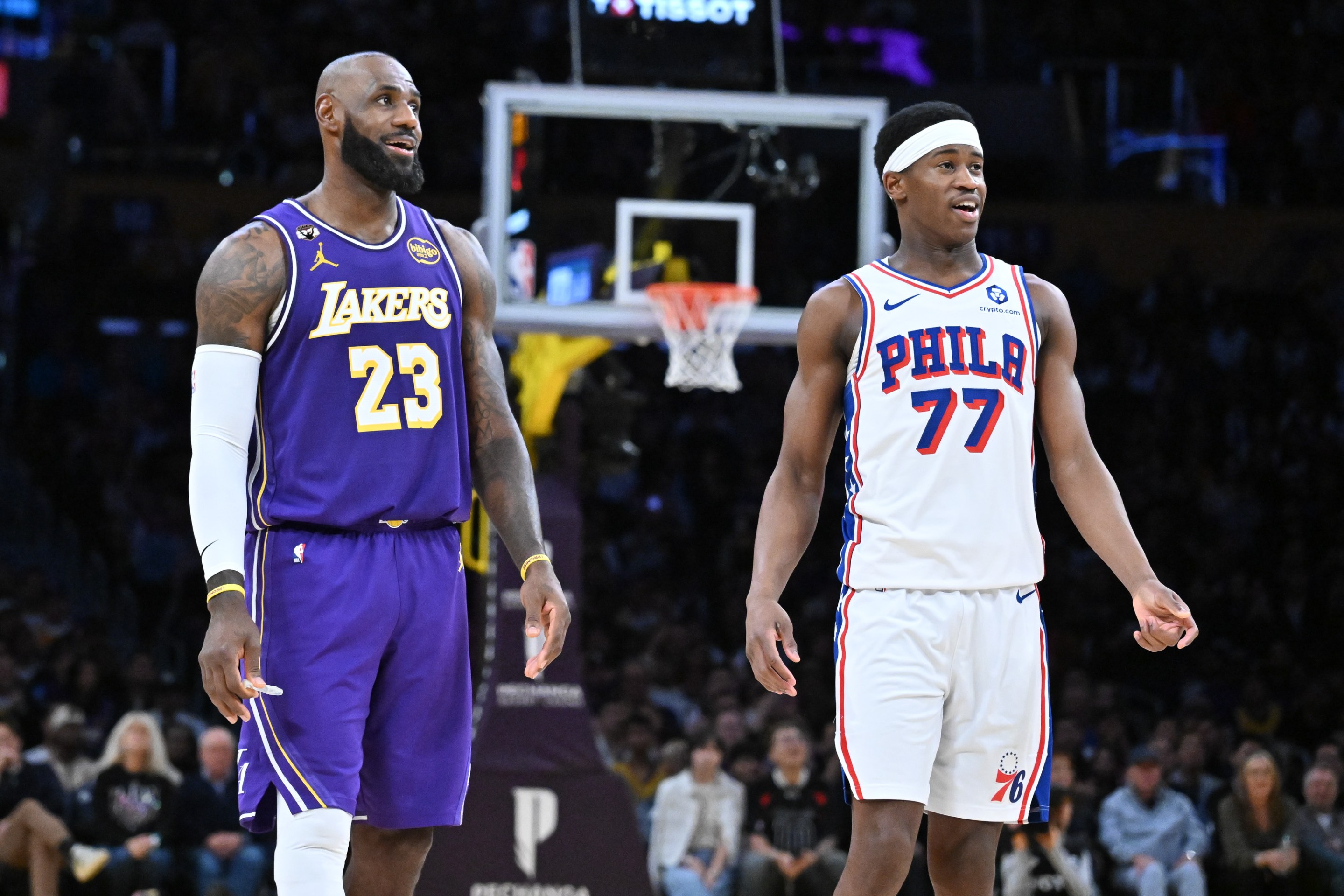 LeBron James #23 of the Los Angeles Lakers and Vj Edgecombe #77 of the Philadelphia 76ers smile during the second half of the game