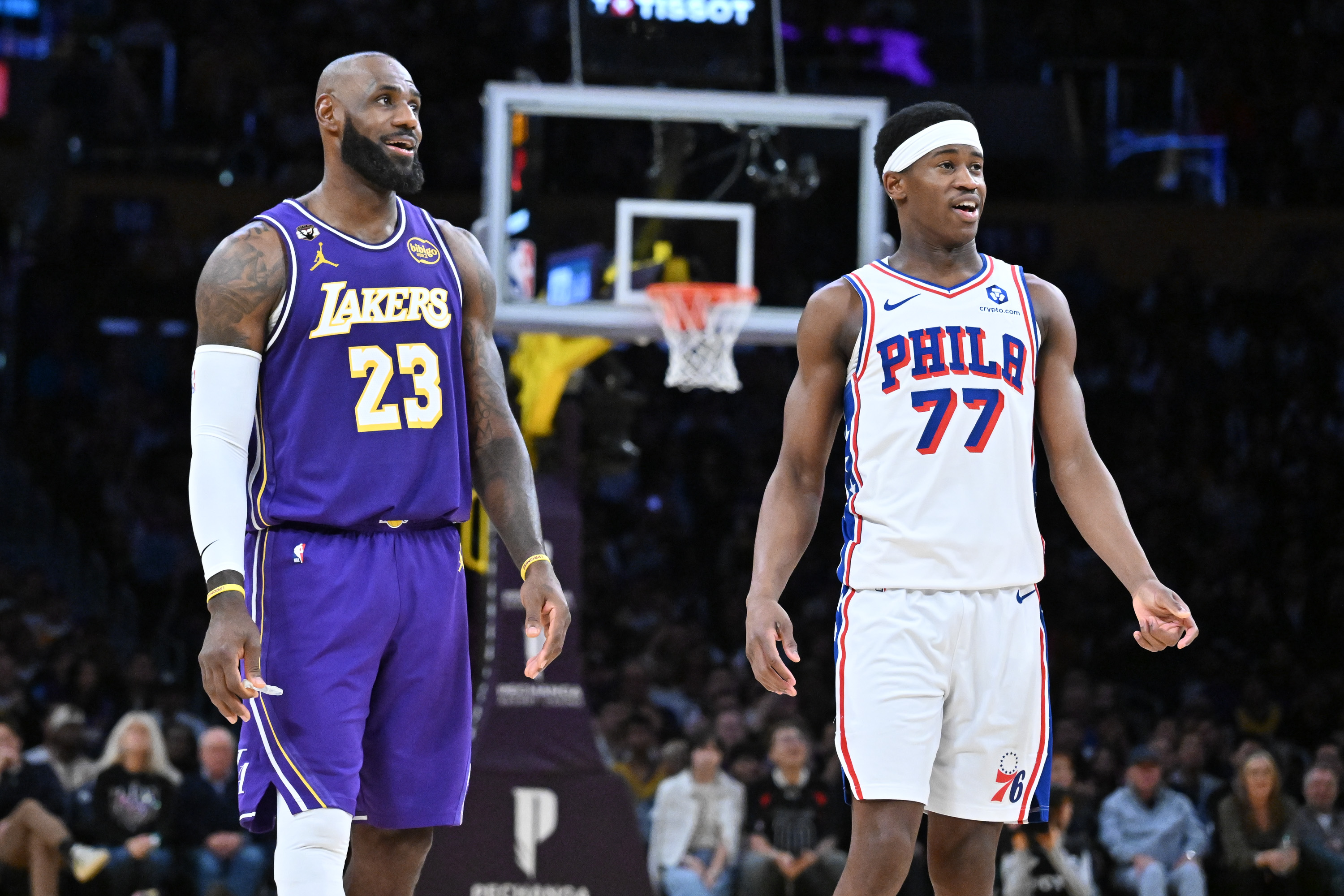LeBron James #23 of the Los Angeles Lakers and Vj Edgecombe #77 of the Philadelphia 76ers smile during the second half of the game