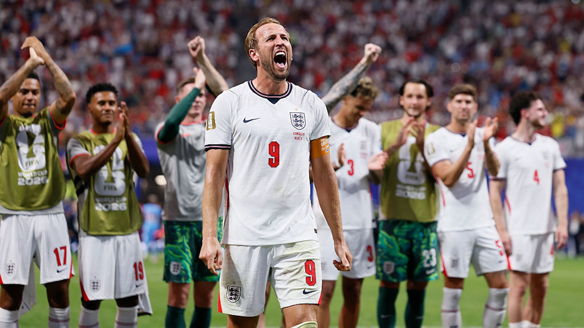 Harry Kane celebrates as his teammates cheer behind him