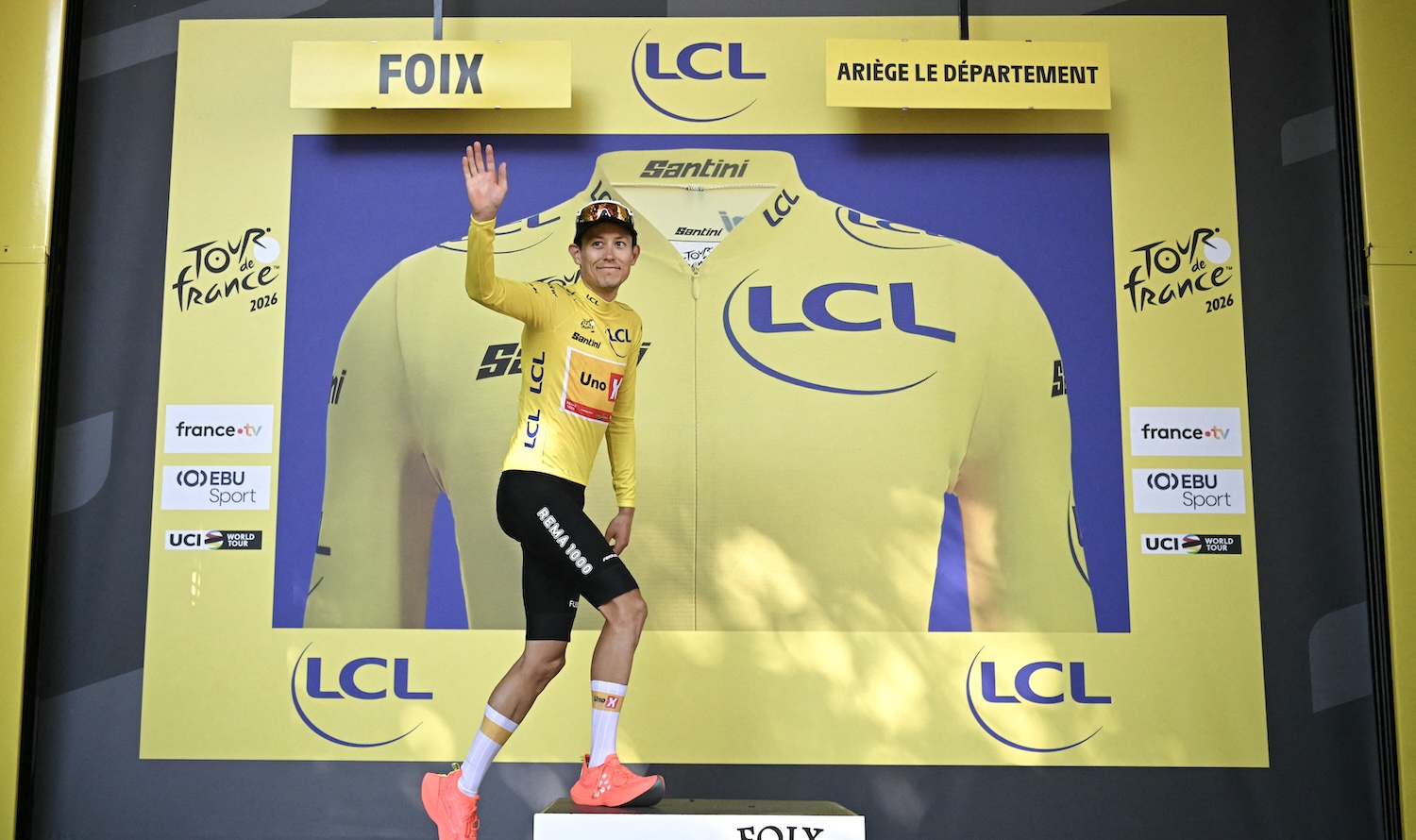 Uno-X Mobility team's Norwegian rider Torstein Træen celebrates on the podium with the overall leader's yellow jersey after the 4th stage of the 113th edition of the Tour de France cycling race, 182 km between Carcassonne and Foix in southwestern France, on July 7, 2026. (Photo by Loic VENANCE / AFP)