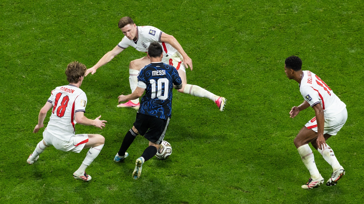 Lionel Messi of Argentina weaves around Elliot Anderson, Anthony Gordon and Jude Bellingham of England during the FIFA World Cup 2026 Semi Final match between England and Argentina