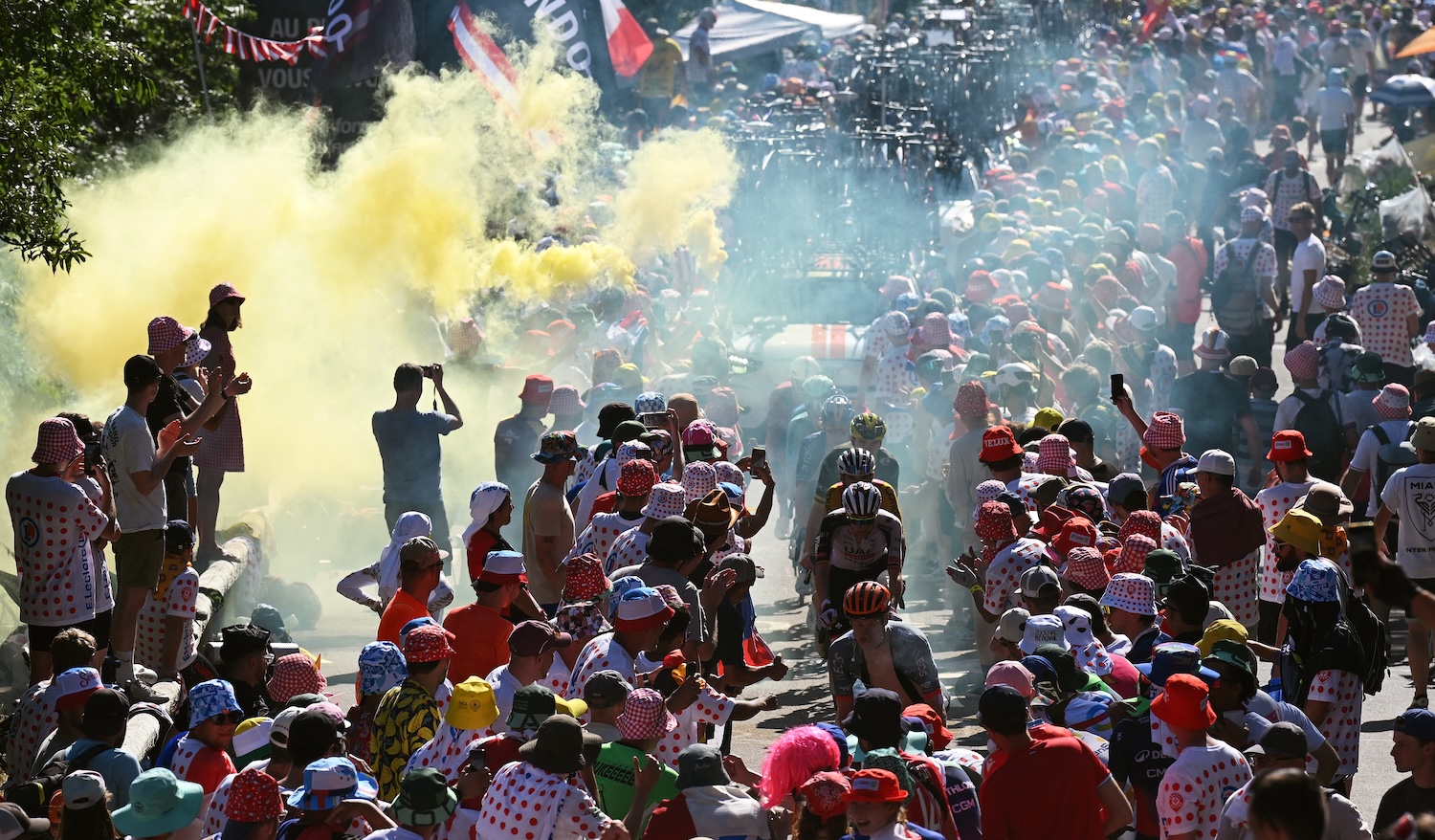 ALPE D'HUEZ, FRANCE - JULY 24: A general view of the peloton compete climbing to the Alpe d'Huez (1835m) while fans cheers during the 113th Tour de France 2026, Stage 19 a 127.9km stage from Gap to Alpe d'Huez 1835m / #UCIWT / on July 24, 2026 in Alpe d'Huez, France. (Photo by Dario Belingheri/Getty Images)