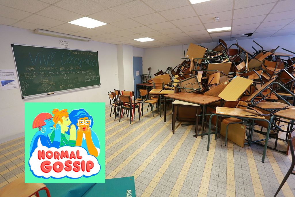 a classroom with desks and chairs piled on top of each other in a corner