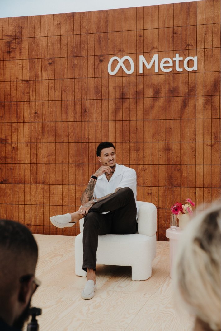 Kyle Kuzma sits very seriously at the Meta offices.