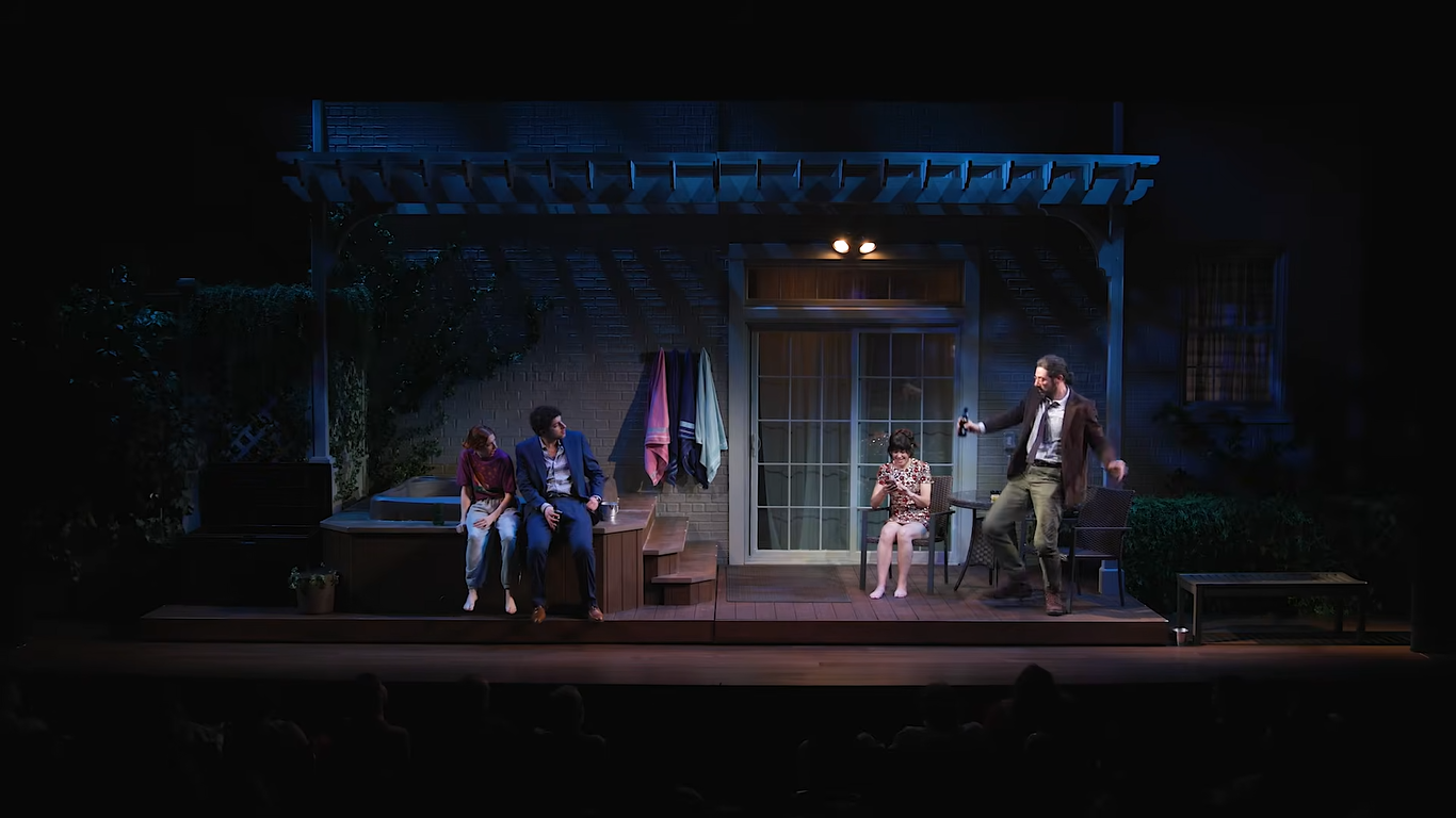 four actors on a set that looks like a dark back porch with a hot tub