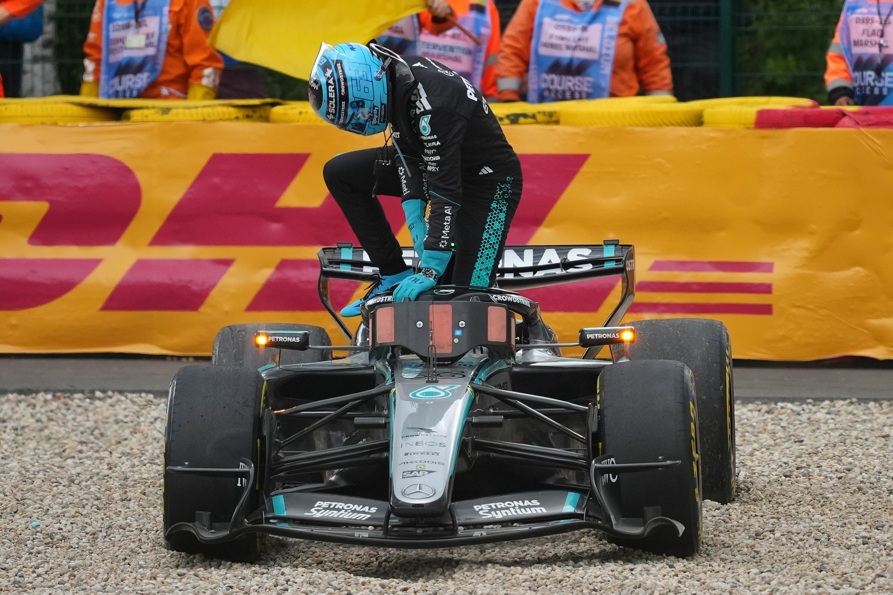 George Russell climbs out of his car after crashing out on the opening lap.