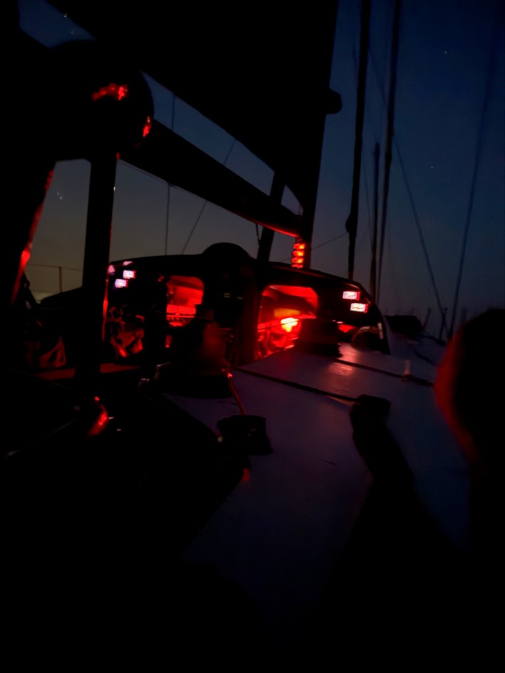 Sisi's deck is illuminated by red light during an overnight watch shift.