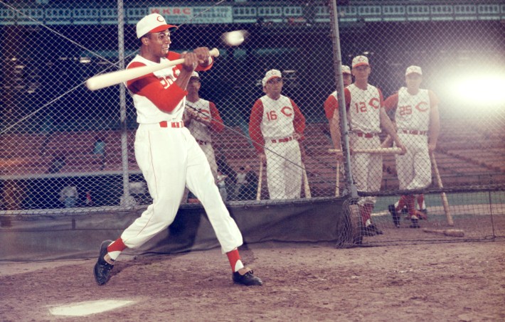 CINCINNATI, OH - 1957:  Frank Robinson #20 of the Cincinnati Redlegs swings at the pitch during batting practice as his teammates Johnny Temple #16, Don Hoak #12 and Gus Bell #25 look on prior to an MLB game circa 1957 at Crosley Field in Cincinnati, Ohio.  (Photo by Hy Peskin/Getty Images)