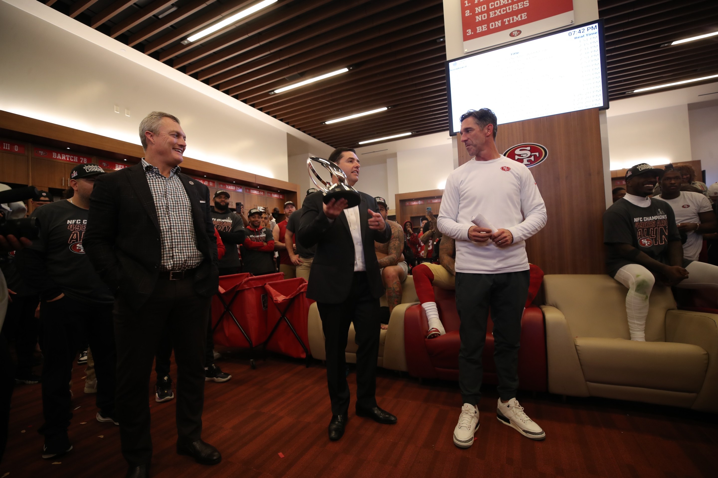 General Manager John Lynch, CEO Jed York and Head Coach Kyle Shanahan of the San Francisco 49ers in the locker room after the NFC Championship game against the Detroit Lions on January 28, 2024.