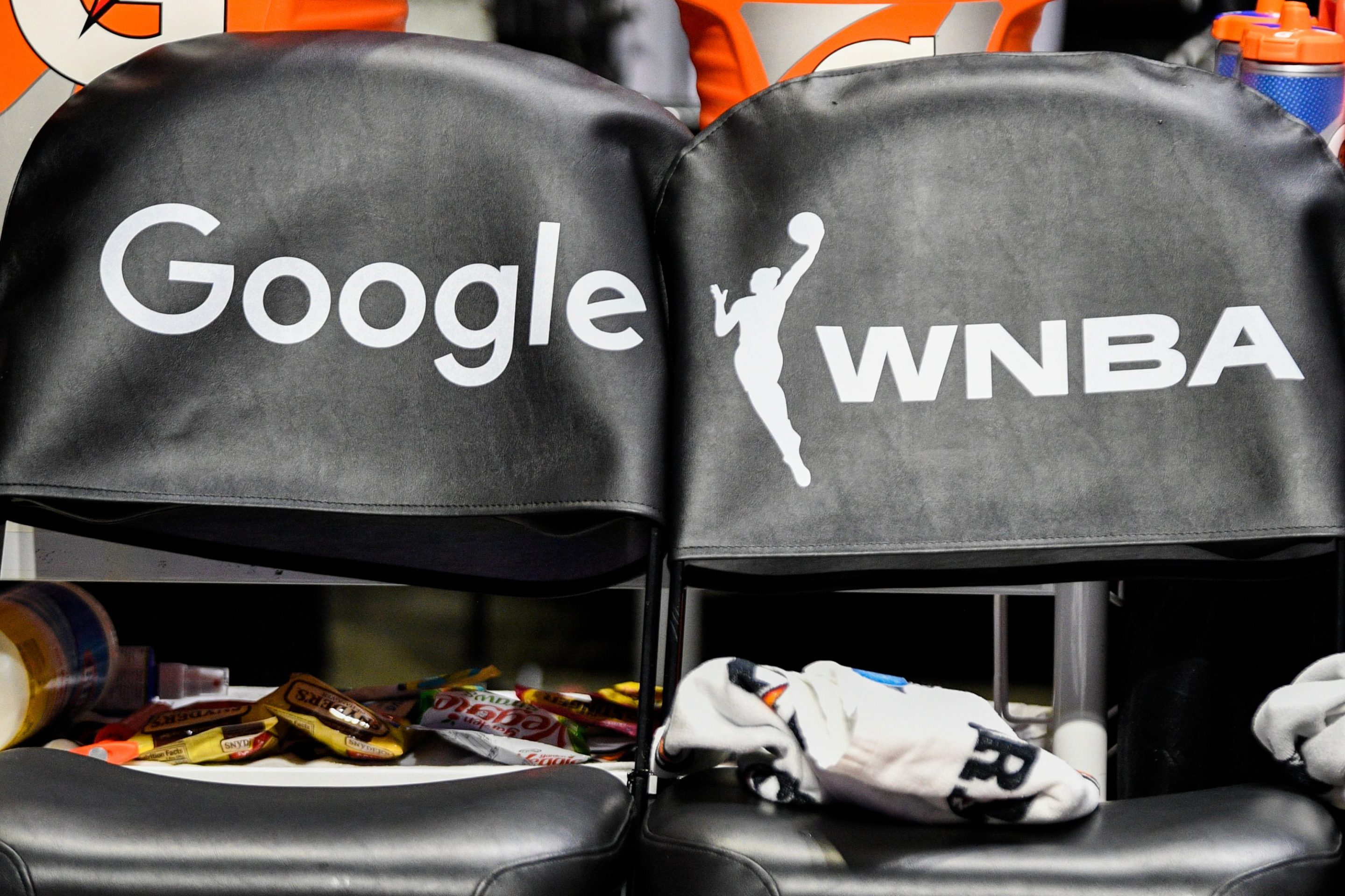 A general view of a "Google" logo and a WNBA logo on seats
