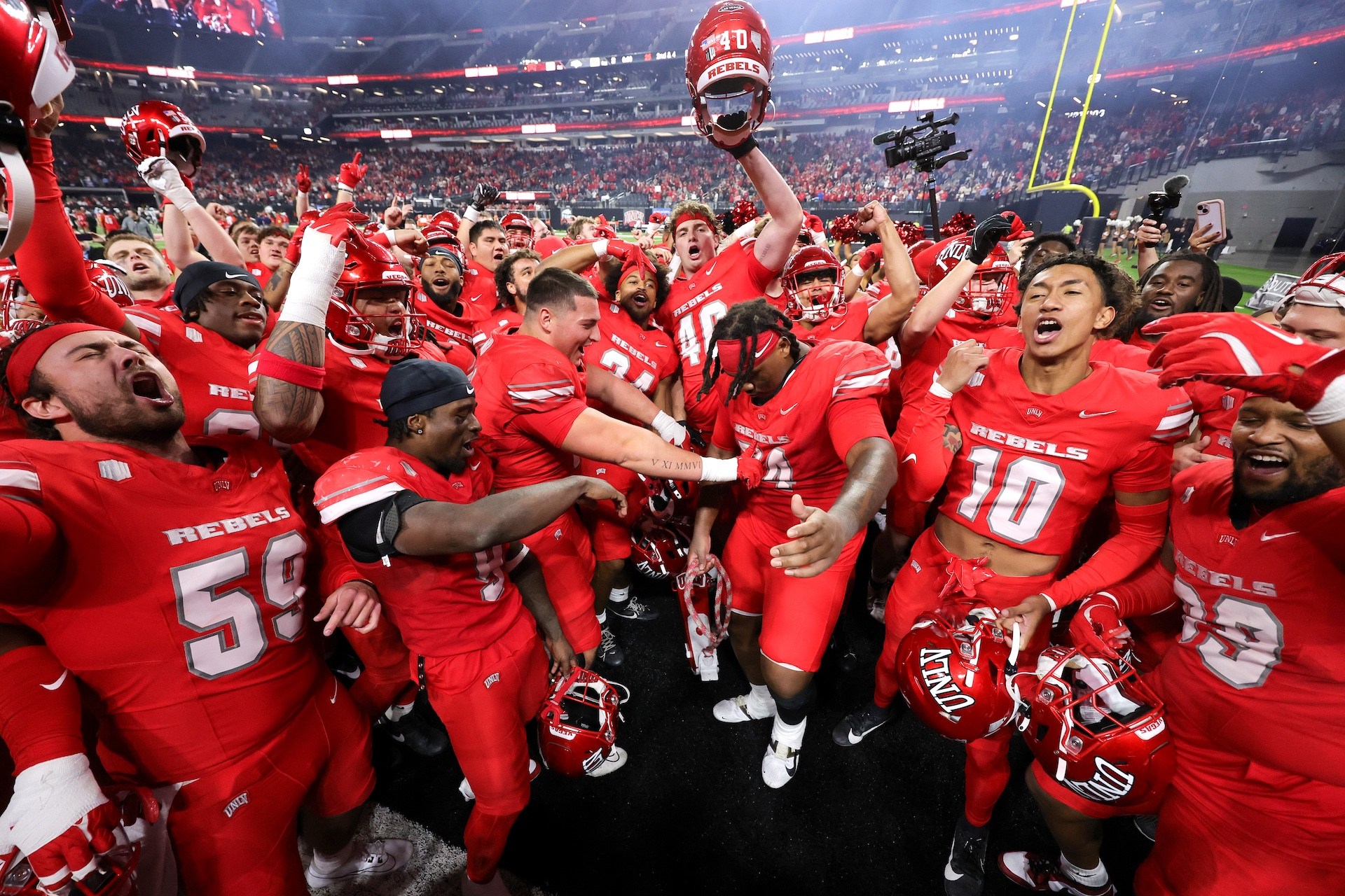 LAS VEGAS, NEVADA - NOVEMBER 30: The UNLV Rebels celebrate on the field after the team's 38-14 victory over the Nevada Wolf Pack at Allegiant Stadium on November 30, 2024 in Las Vegas, Nevada.