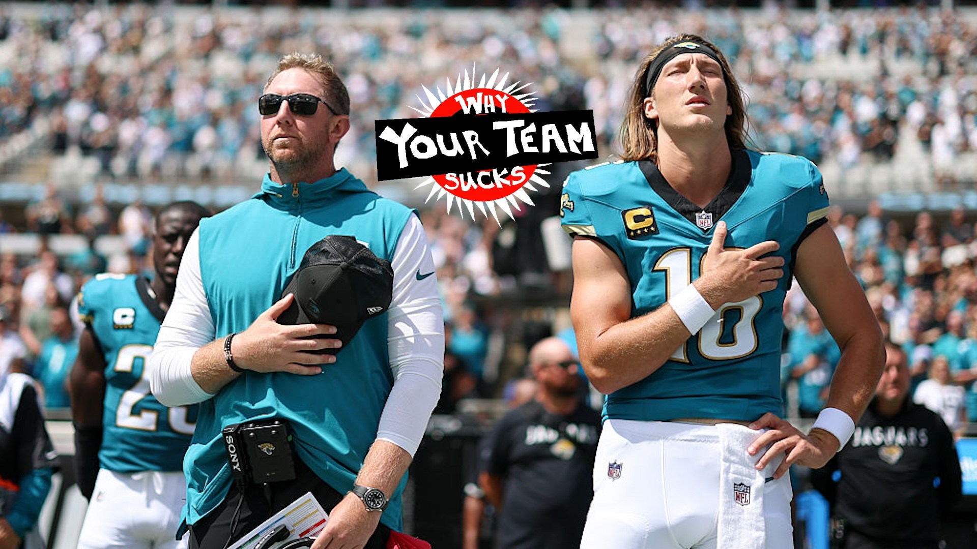 Head coach Liam Coen and Trevor Lawrence #16 of the Jacksonville Jaguars stand for the national anthem prior to a NFL football game against the Houston Texans
