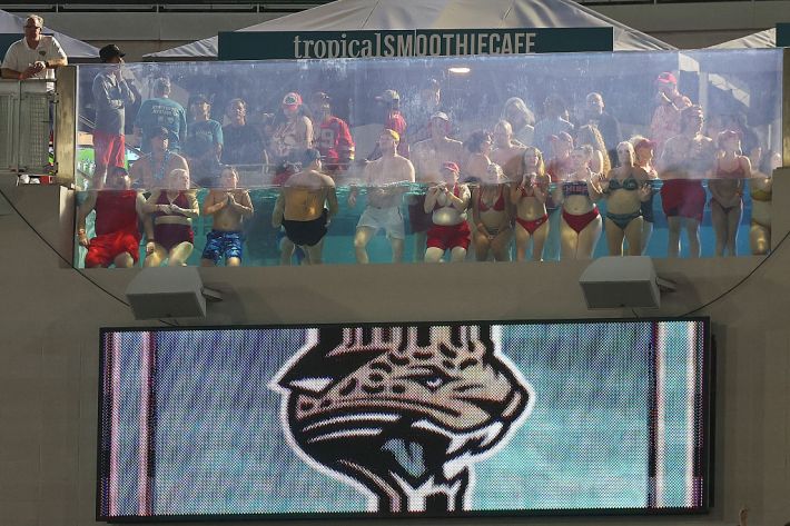 Fans watch the game between the Jacksonville Jaguars and the Kansas City Chiefs from a swimming pool at EverBank Stadium