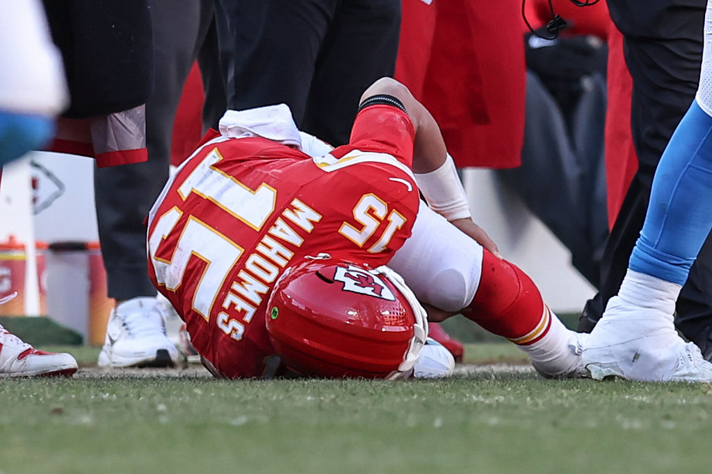 Kansas City Chiefs quarterback Patrick Mahomes (15) lies on the ground holding his knee after being injured in the fourth quarter of an NFL game between the Los Angeles Chargers and Kansas City Chiefs