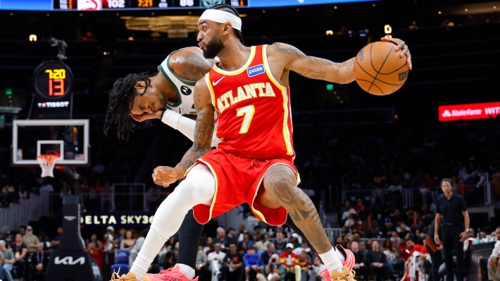 Nickeil Alexander-Walker #7 of the Atlanta Hawks commits an offensive foul against Kevin Porter Jr. #7 of the Milwaukee Bucks during the fourth quarter at State Farm Arena on March 14, 2026 in Atlanta, Georgia.
