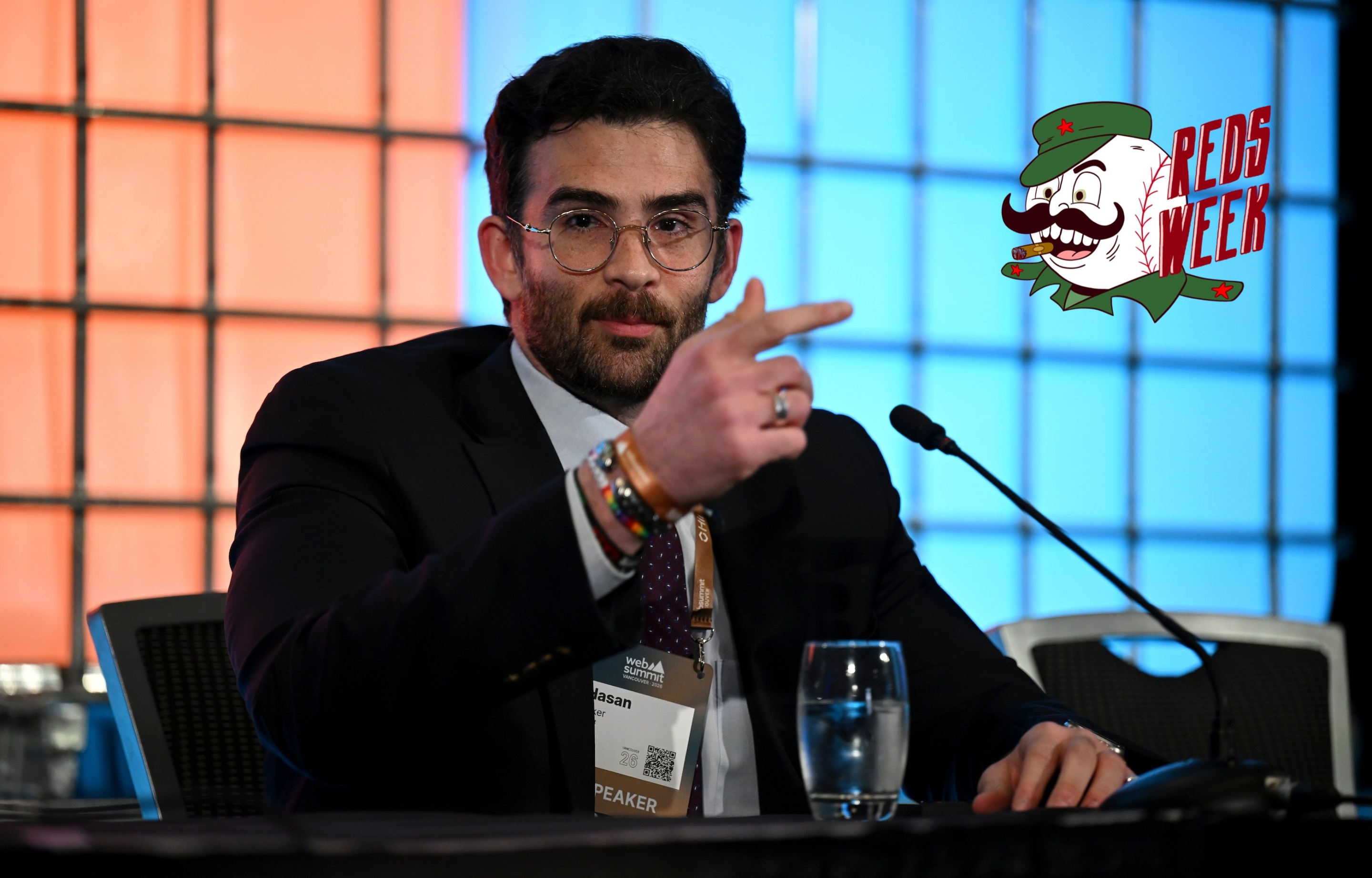 Hasan Piker, Streamer &amp; Creator, Night, at a press conference during day two of Web Summit Vancouver 2026 at Vancouver Convention Centre. The Reds Week logo is at right.