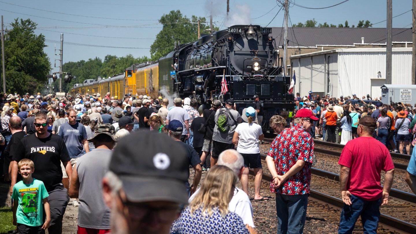 TAMA, IOWA - JUNE 01: People gather along the railroad tracks to watch as Union Pacific’s Big Boy No. 4014, the world’s largest operating steam locomotive, makes a stop in the city's downtown during its cross-country journey to celebrate America's 250th birthday on June 1, 2026 in Tama, Iowa. Between 1941 and 1944 Union Pacific commissioned 25 Big Boy locomotives, eight still remain, but the restored 4014 is the only one that is fully operational.  (Photo by Scott Olson/Getty Images)